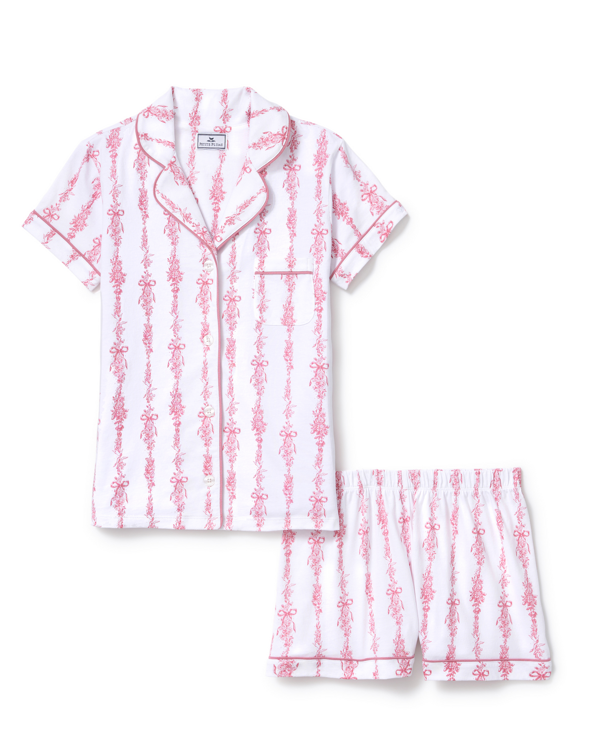 The Poppy Pima Short Set in Pink Mayfair Toile features a short-sleeve white button-up top with a collar, pocket, and matching shorts, adorned with pink vertical floral stripes.