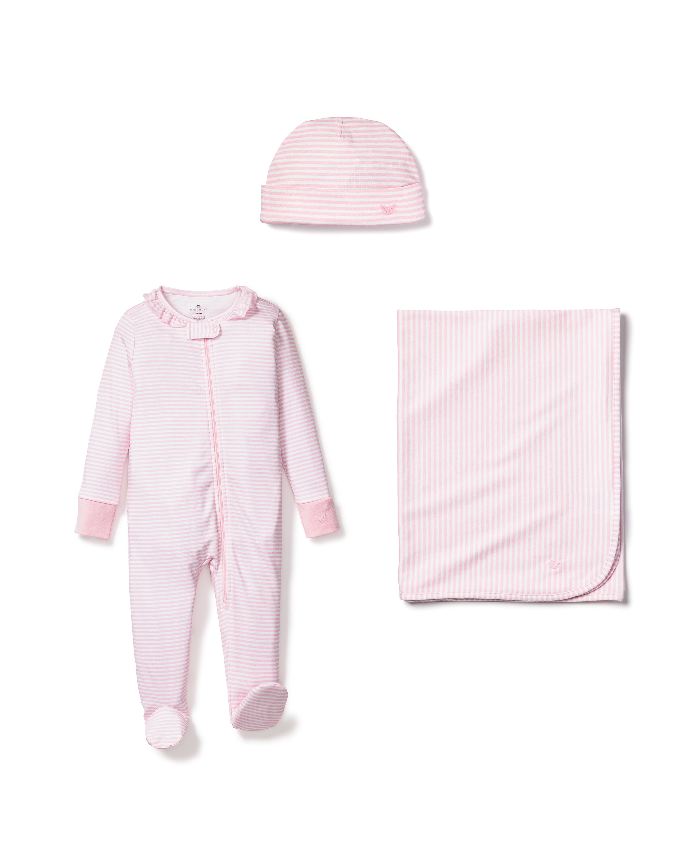 The Petite Plume Welcome Home Baby Set - Pink Stripe includes a light pink and white striped footed romper with a ruffled collar, a matching hat, and a blanket, all displayed side by side on a white background.
