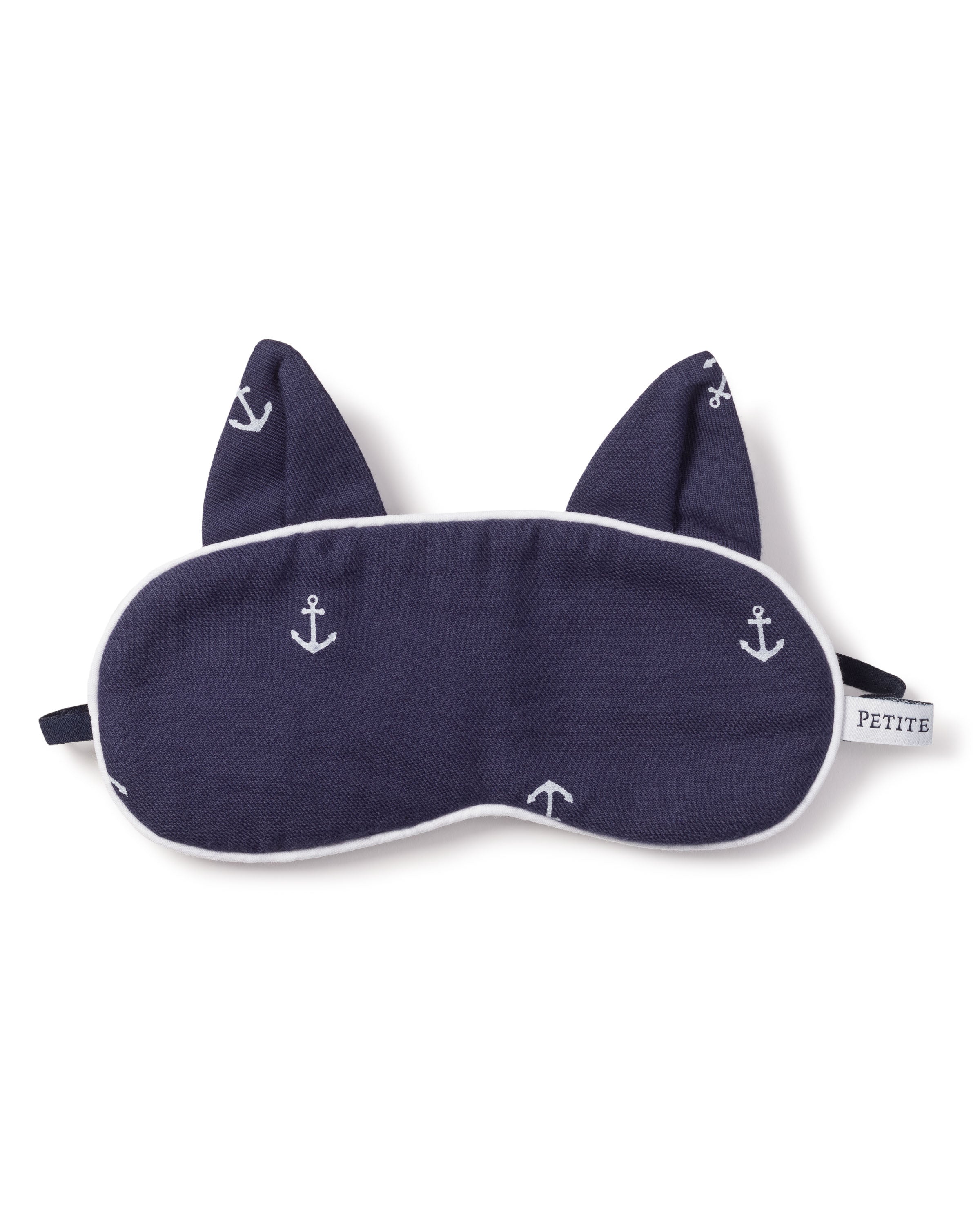 The Kids Twill Kitty Sleep Mask in Portsmouth Anchors by Petite Plume adds luxury to your sleepwear collection with its navy blue color, white anchor patterns, and cat ear shapes. A subtle PETITE monogram on the tag and a black elastic strap complete the design for comfort.