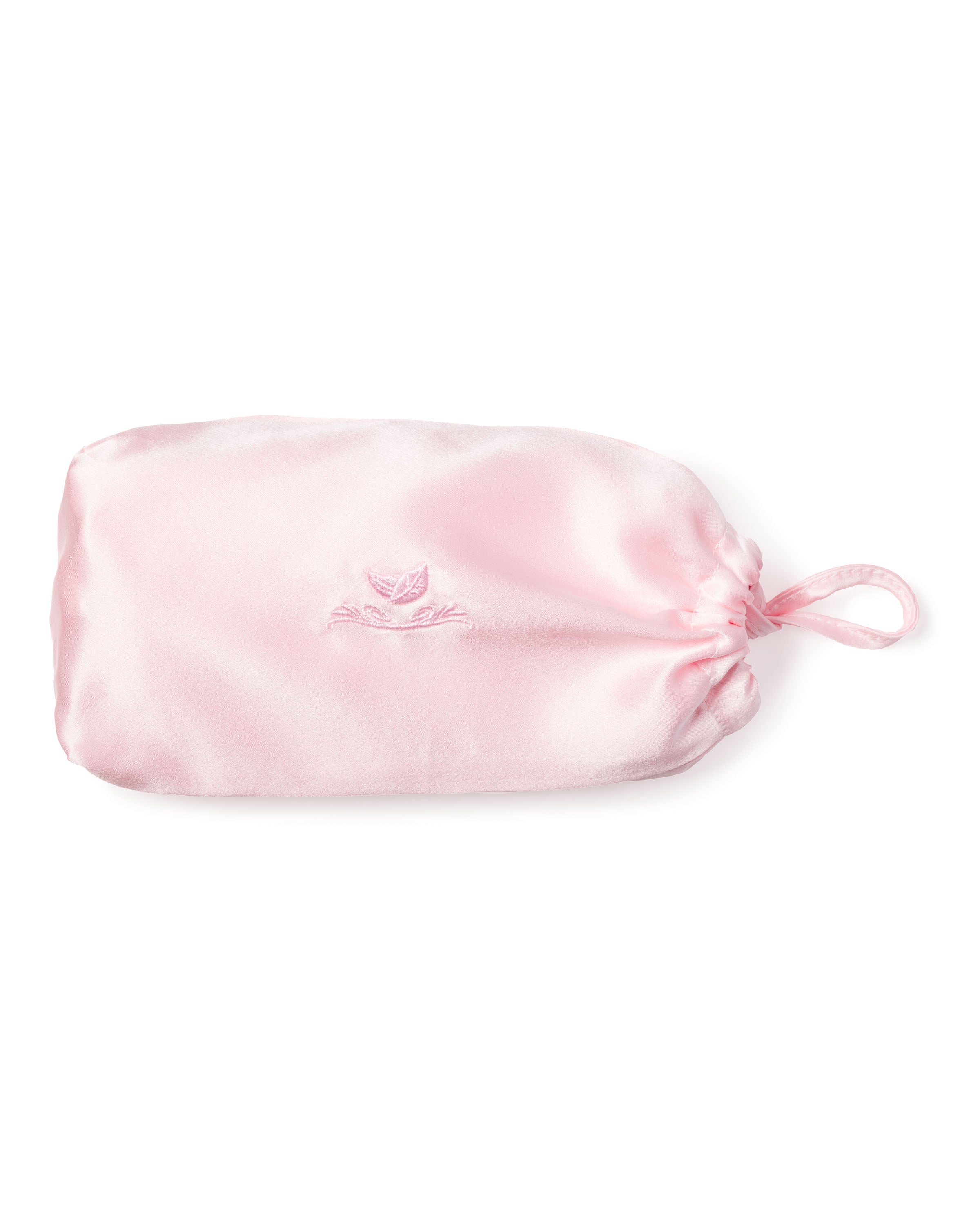 The Silk Pillow Cover in Pink by Petite Plume features a light pink satin drawstring pouch, reminiscent of the finest 22mm silk. It is cinched with a matching ribbon and bears a subtle embroidered logo, offering a smooth, glossy texture perfect for your sweetest dreams.