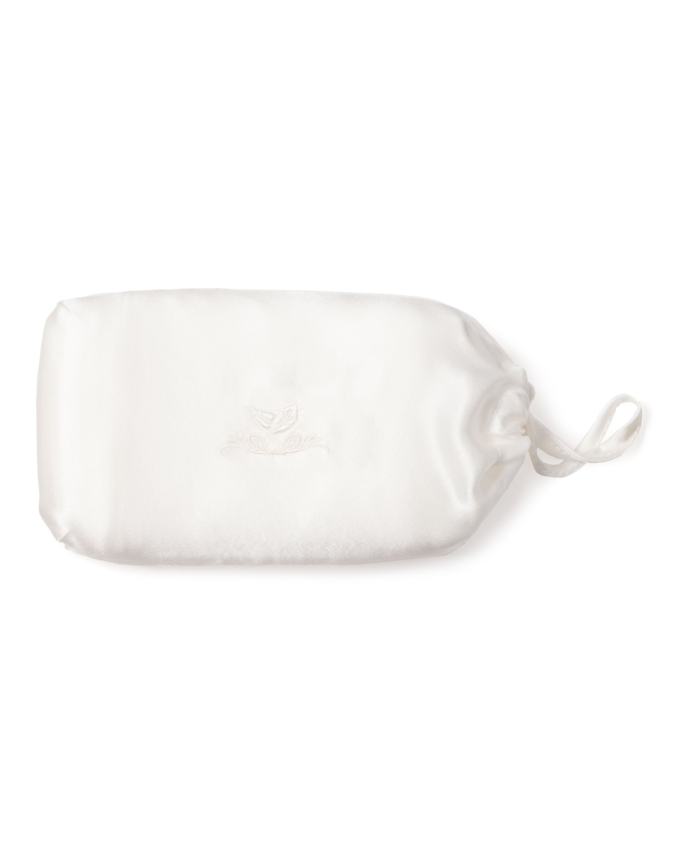 A luxurious rectangular white eye mask made from 22mm pure silk features a subtle embroidered center design. It has adjustable straps for a secure fit and rests elegantly on a plain white background. From the collection of Petite Plume, known for their Silk Pillow Cover in White.