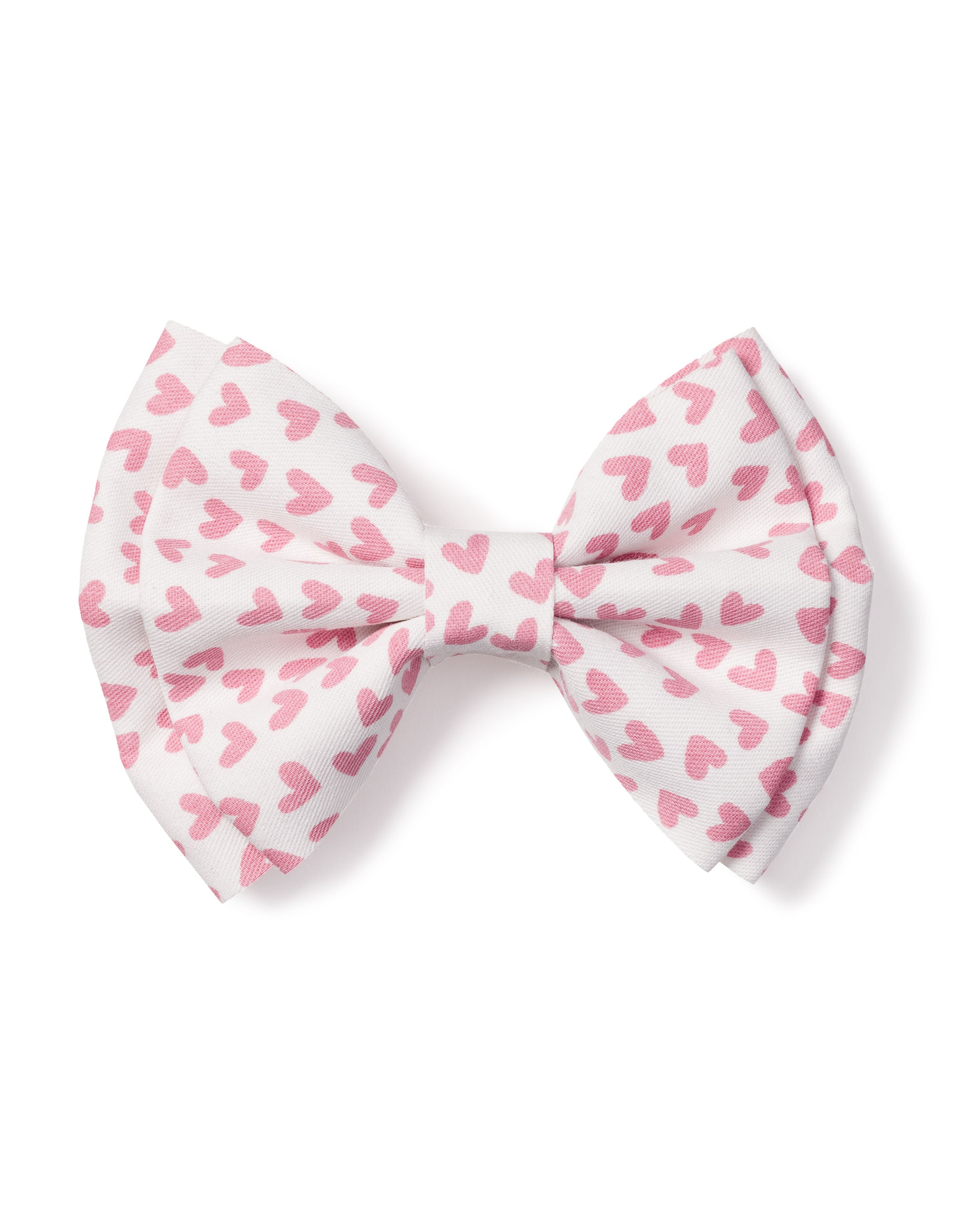 The Girls Hair Bows in Sweethearts by Petite Plume, featuring white bows with pink heart patterns, make the perfect holiday gift or stocking stuffer for any festive occasion.