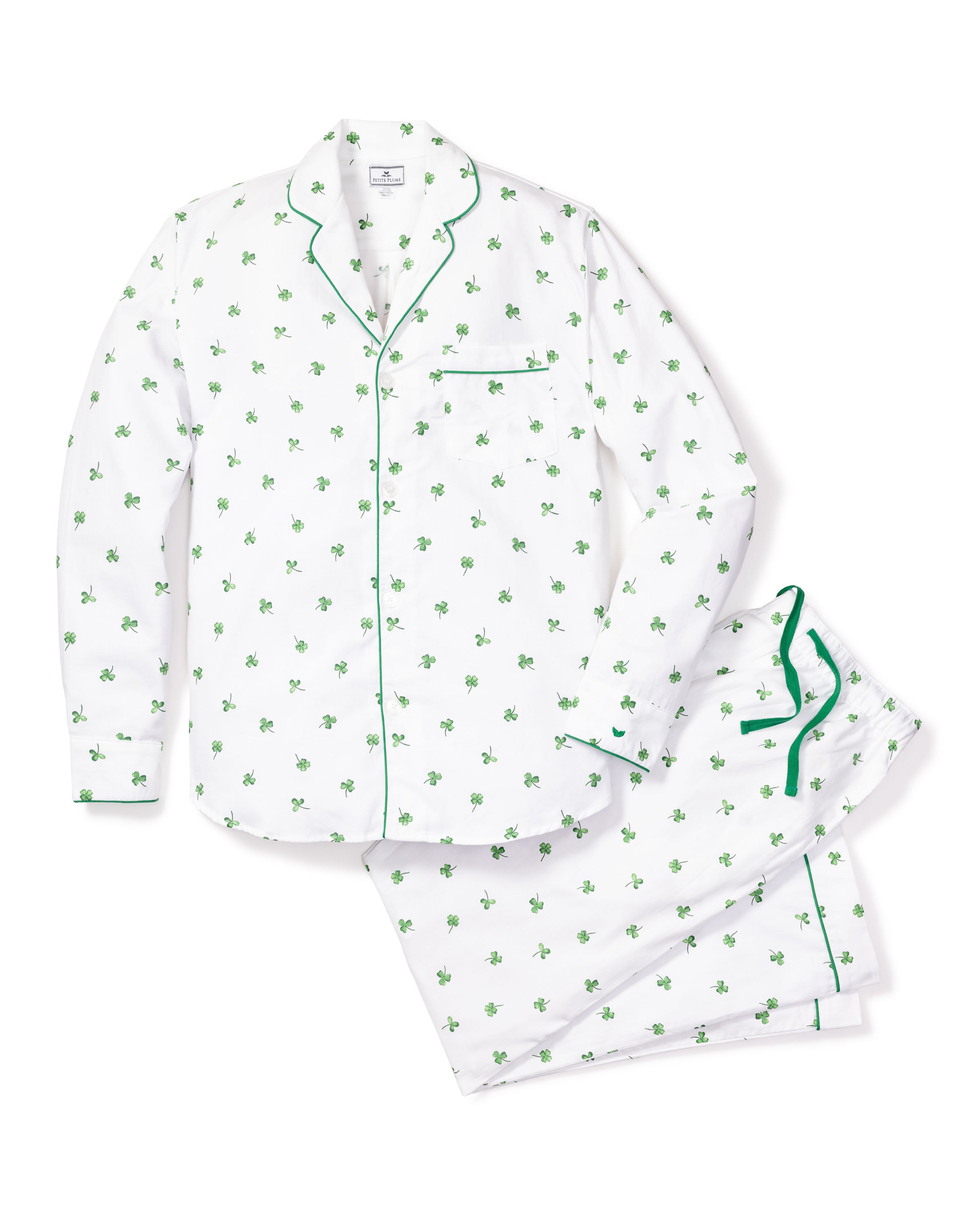 Discover Petite Plumes Mens Twill Pajama Set in Shamrocks: a white long-sleeve button-up shirt with a green clover pattern and elegant piping, paired with elastic waistband pants for simple, festive luxury.