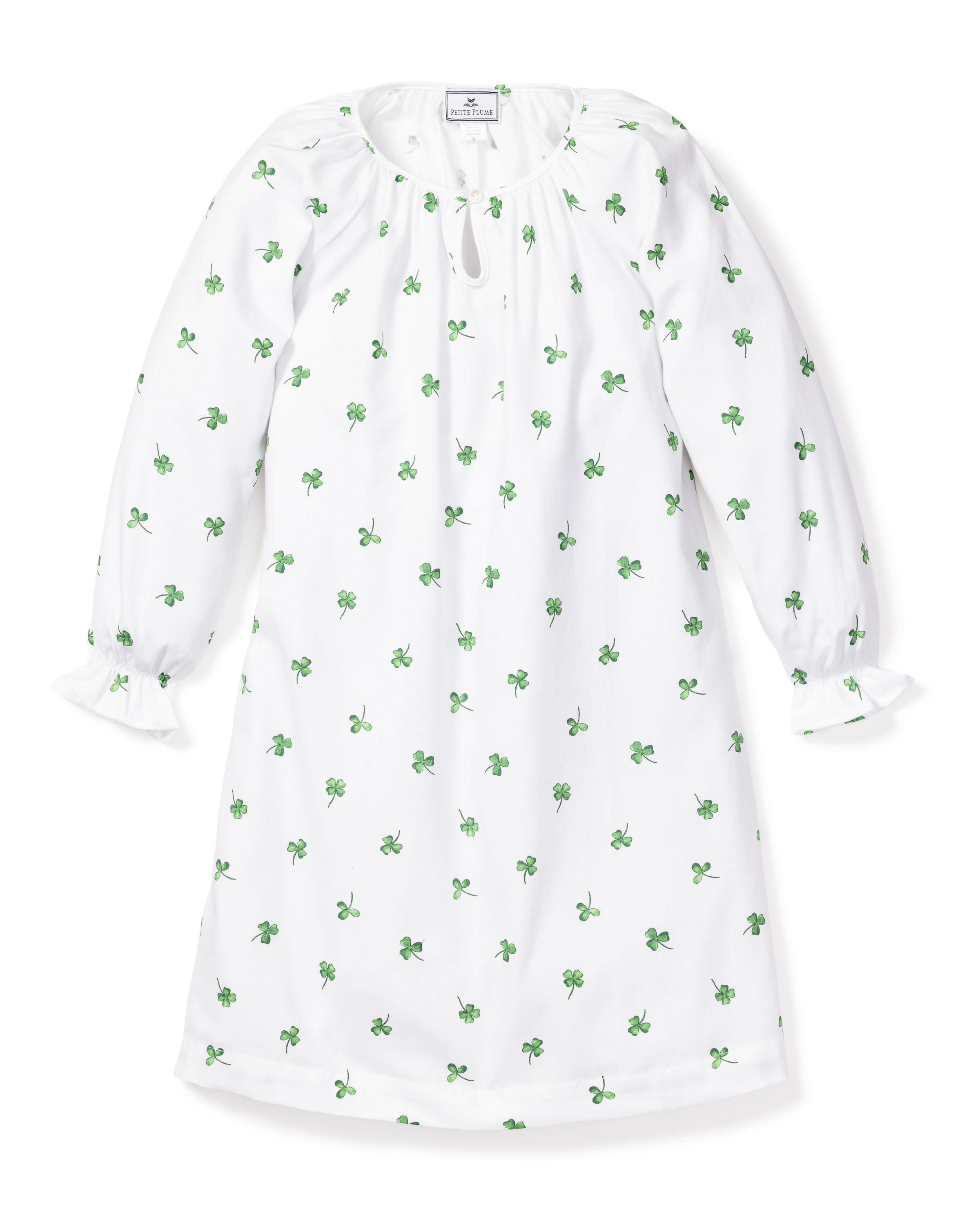 Introducing the Girls Twill Delphine Nightgown in Shamrocks by Petite Plume: a white long-sleeve dress adorned with a green floral pattern, featuring a round neckline with a small front slit and keyhole. The sleeves gather at the wrists with subtle ruffle detail for luxurious sleepwear comfort.
