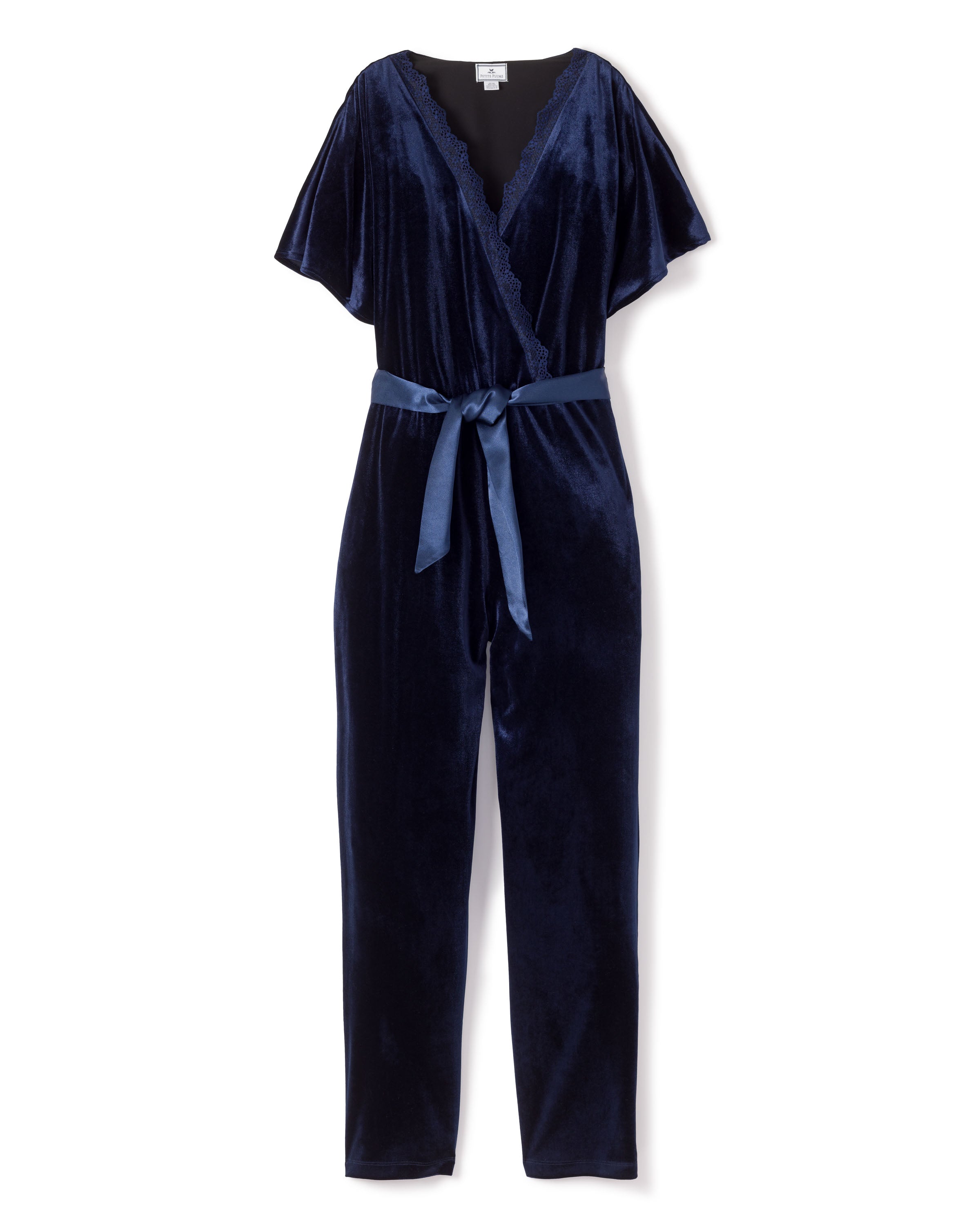 The Womens Velour Jumpsuit in Navy from Petite Plume channels classic Hollywood style with a deep blue hue, short wide sleeves, V-neck, and a cinched waist tied with a matching sash.