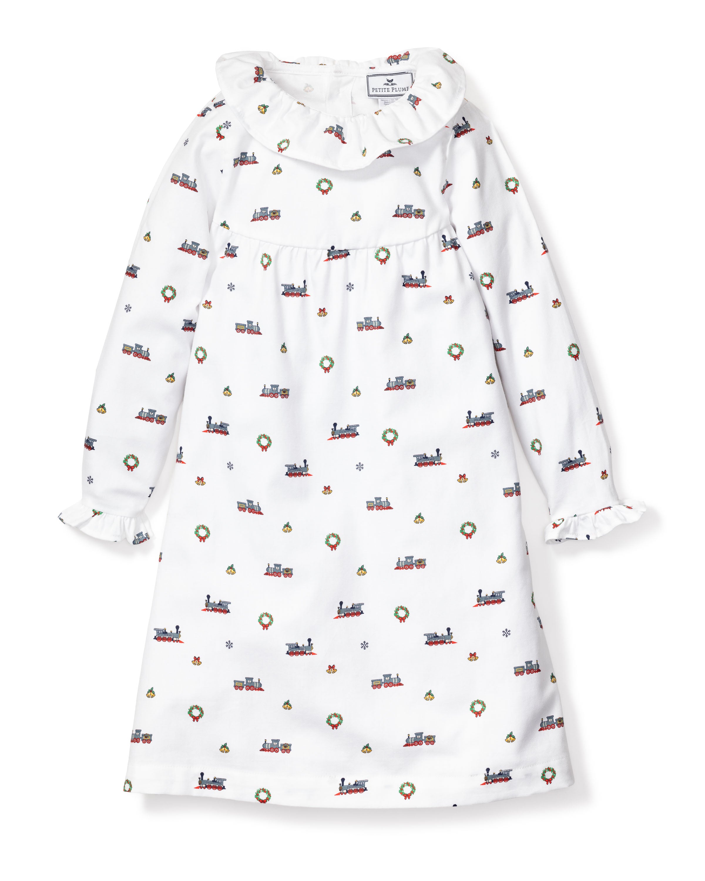 The Girls Twill Scarlett Nightgown in Arctic Express by Petite Plume offers cozy-soft white twill with a ruffled collar and cuffs, adorned with festive prints of trains, wreaths, and snowflakes, perfect holiday sleepwear.