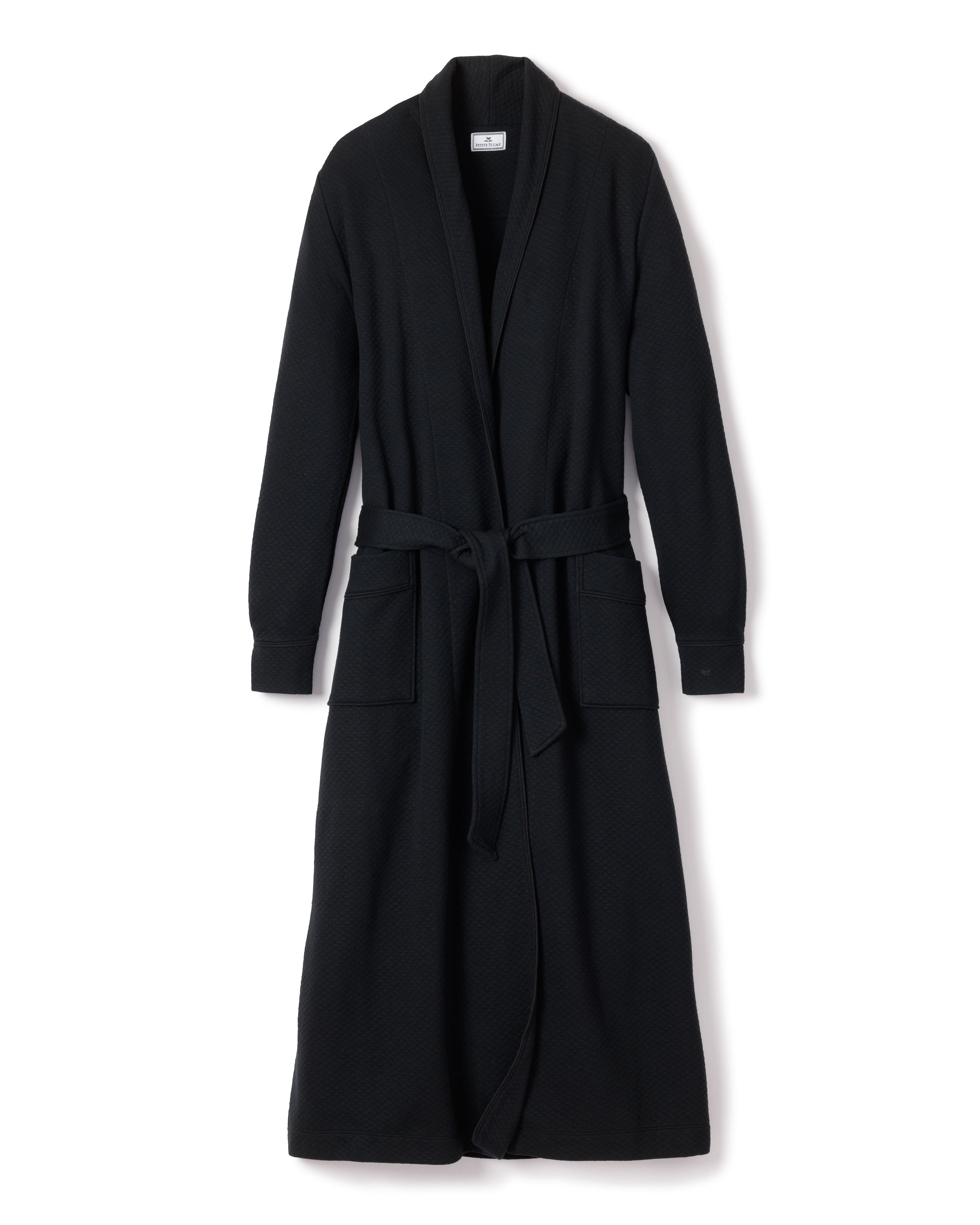 The Womens Pima Ophelia Robe in Black Jacquard by Petite Plume is a luxurious bathrobe crafted from Peruvian Pima cotton. It features a textured fabric, shawl collar, tied belt, two front pockets, and a subtle quilted effect for added elegance.