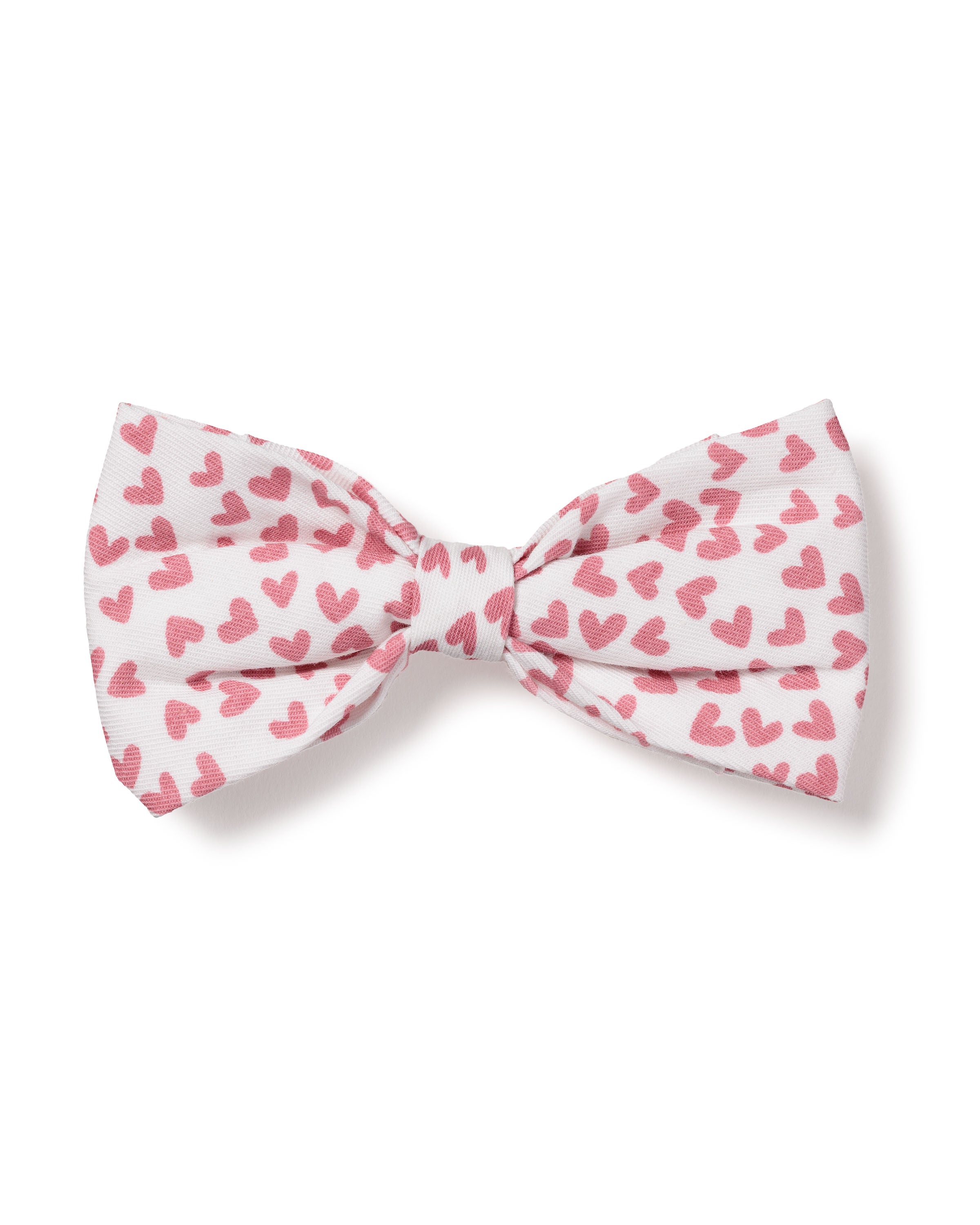 The charming Dog Bow Tie in Sweethearts by Petite Plume is crafted from enchanting fabrics, featuring a white background adorned with small red hearts.
