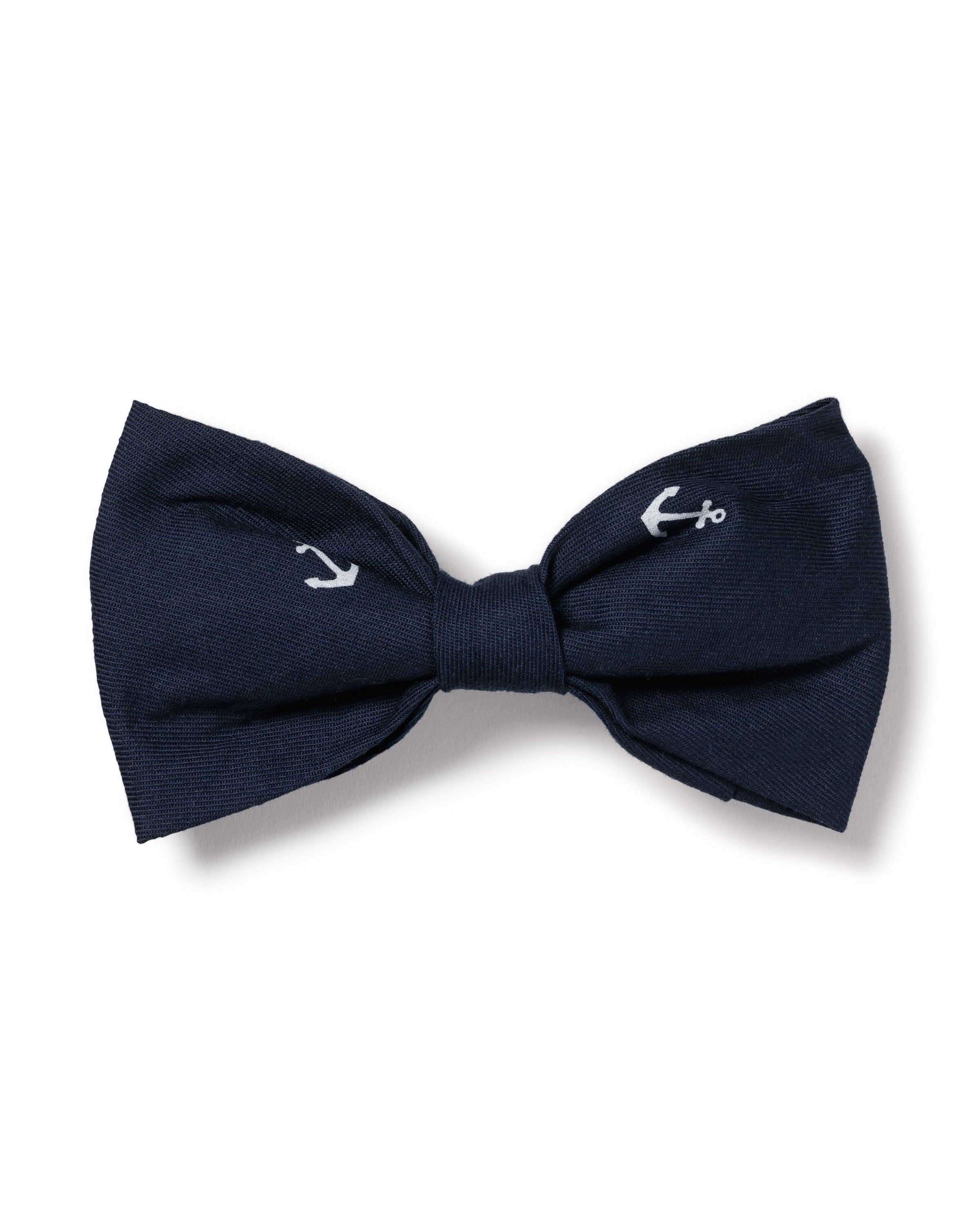The Dog Twill Bow Tie in Portsmouth Anchors by Petite Plume, featuring a navy blue base with small white anchor designs on each side, is an ideal festive accessory for dogs.