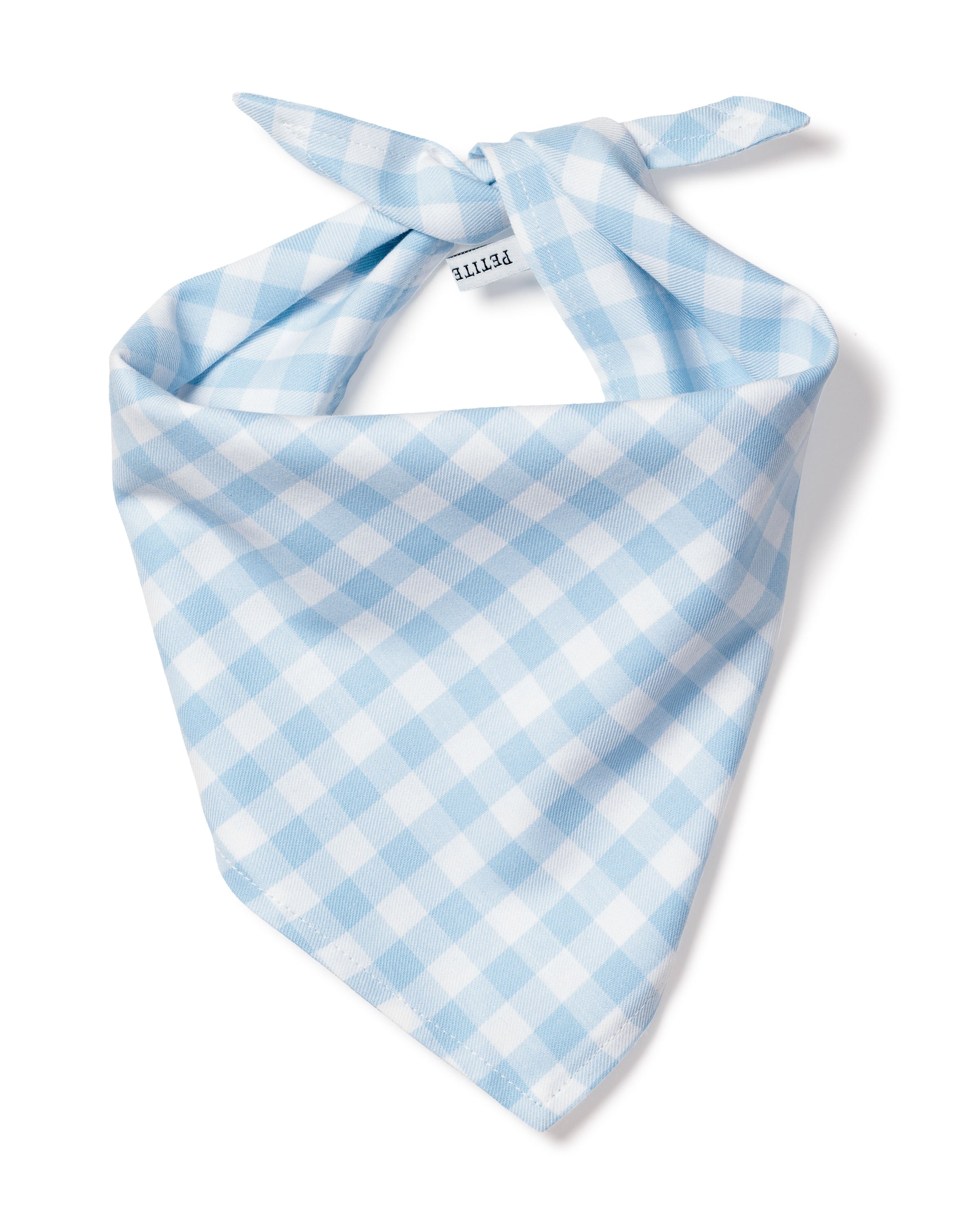 The Dog Twill Bandana Light Blue Gingham by Petite Plume is a charming blue and white checkered accessory with a tied knot and small label, featuring evenly spaced squares. Crafted from soft, lightweight fabric, its an ideal addition to any stylish dog accessory collection.
