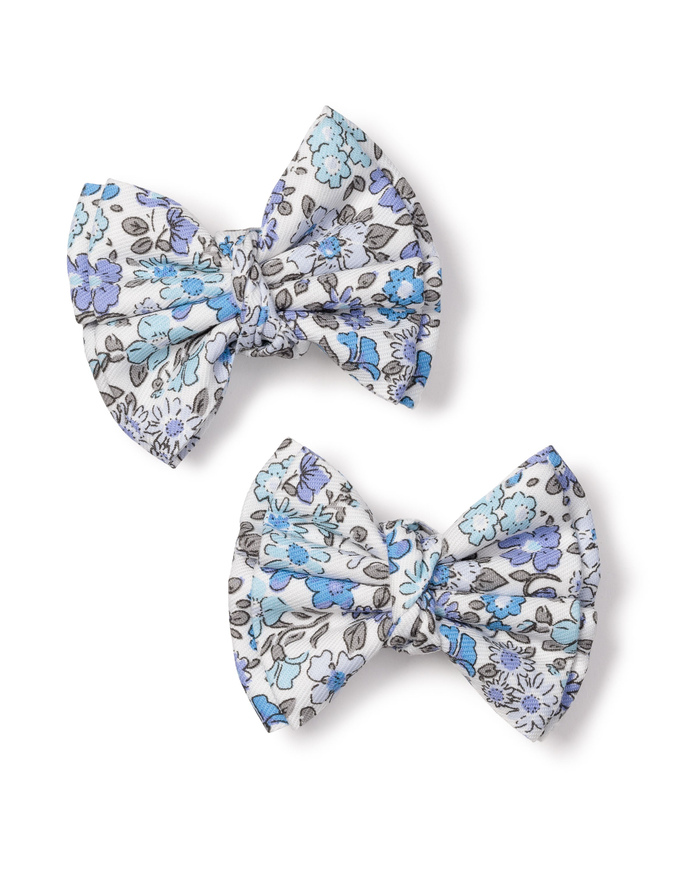 The Girls Twill Hair Bows in Fleur DAzur by Petite Plume are two charming fabric hair bows featuring a blue and gray floral pattern on a white background, elegantly showcasing their design and texture.