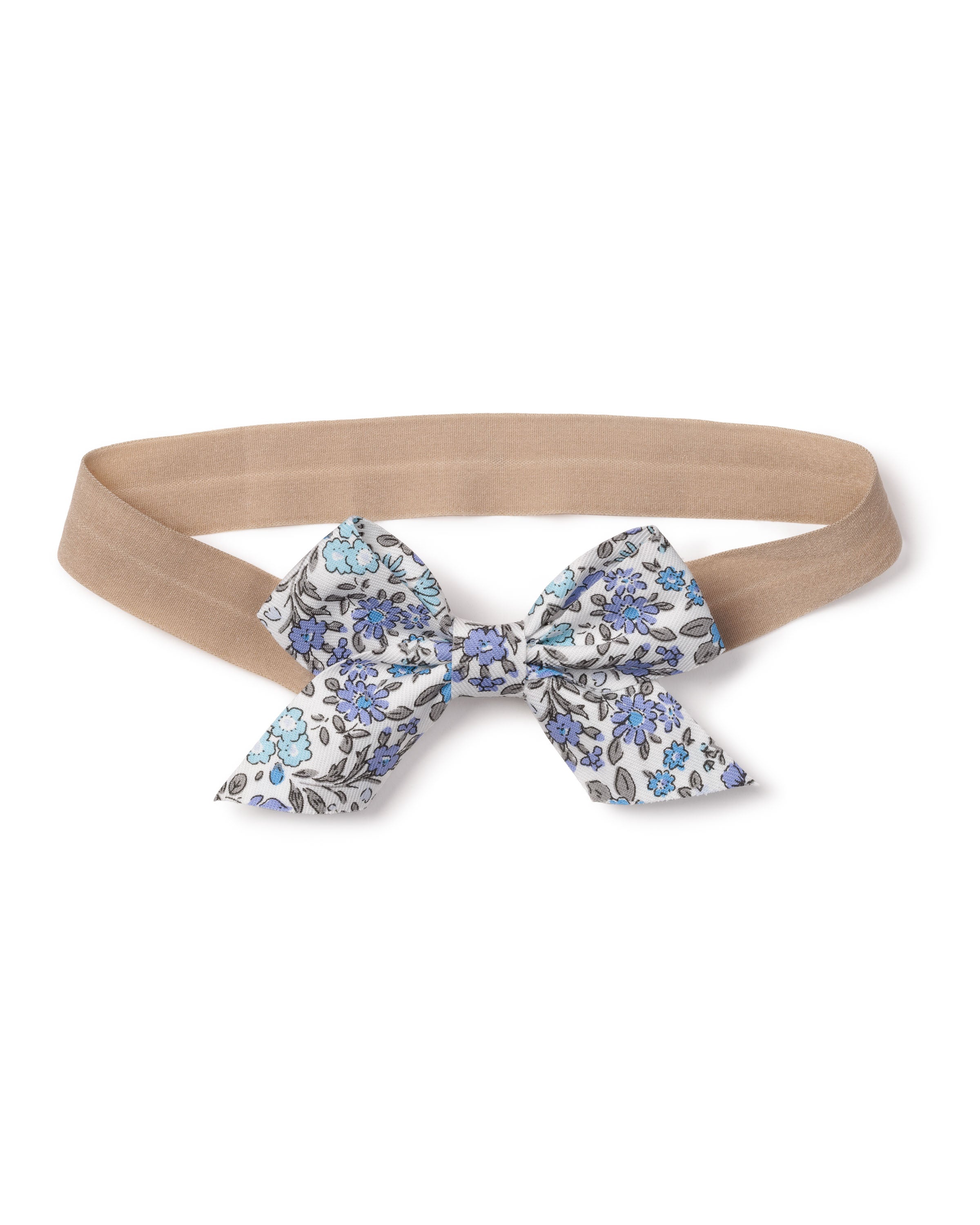 The Girls Twill Hair Bows in Fleur DAzur by Petite Plume feature charming fabrics with an elastic beige band and a decorative bow adorned with a blue and black floral pattern on white. This delightful accessory adds an enchanting touch to any girls ensemble.