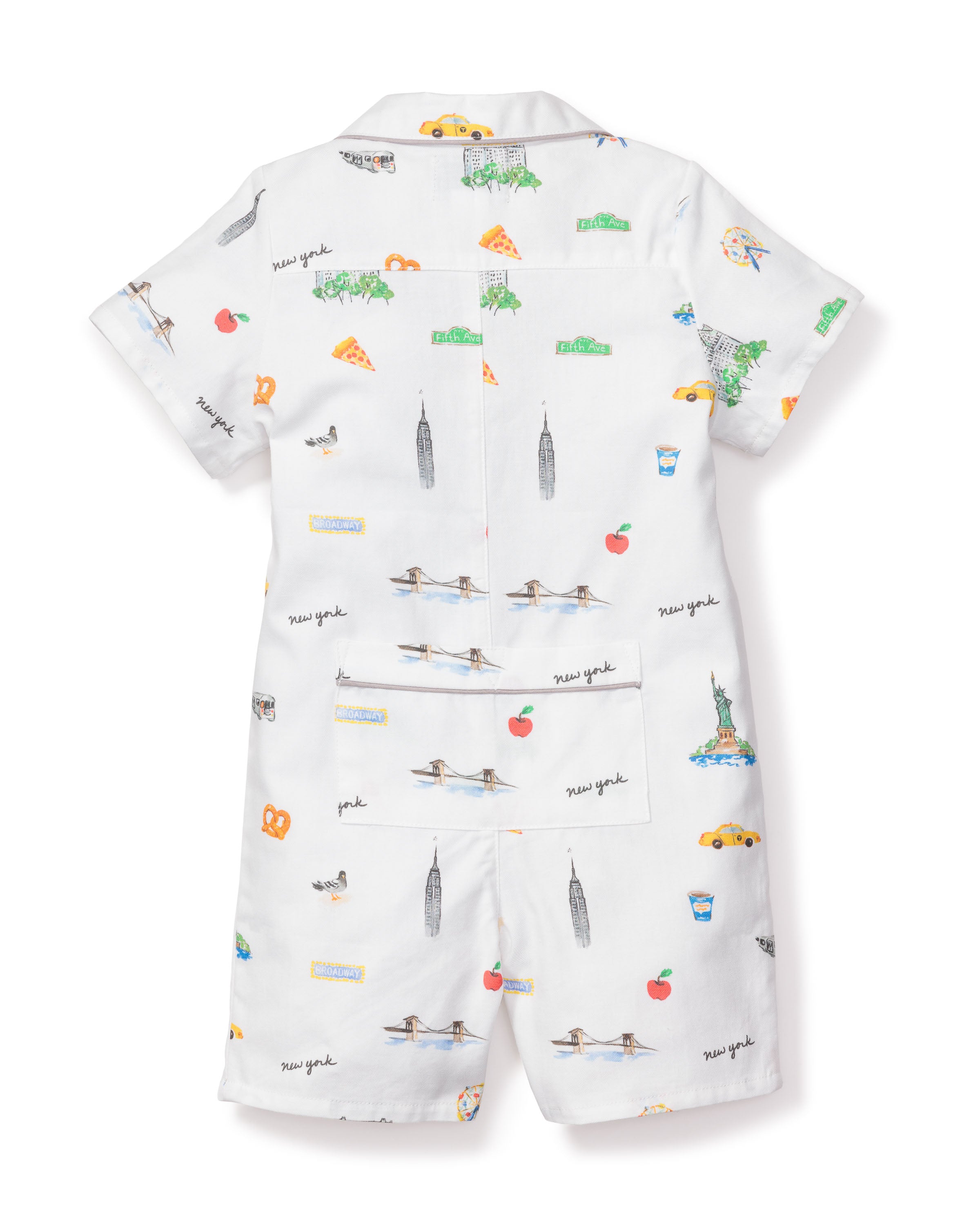 The Babys Twill Summer Romper by Petite Plume features New York-themed illustrations, like pizza and the Statue of Liberty, yarn-dyed cotton fabric, New York text, short sleeves, and shorts.