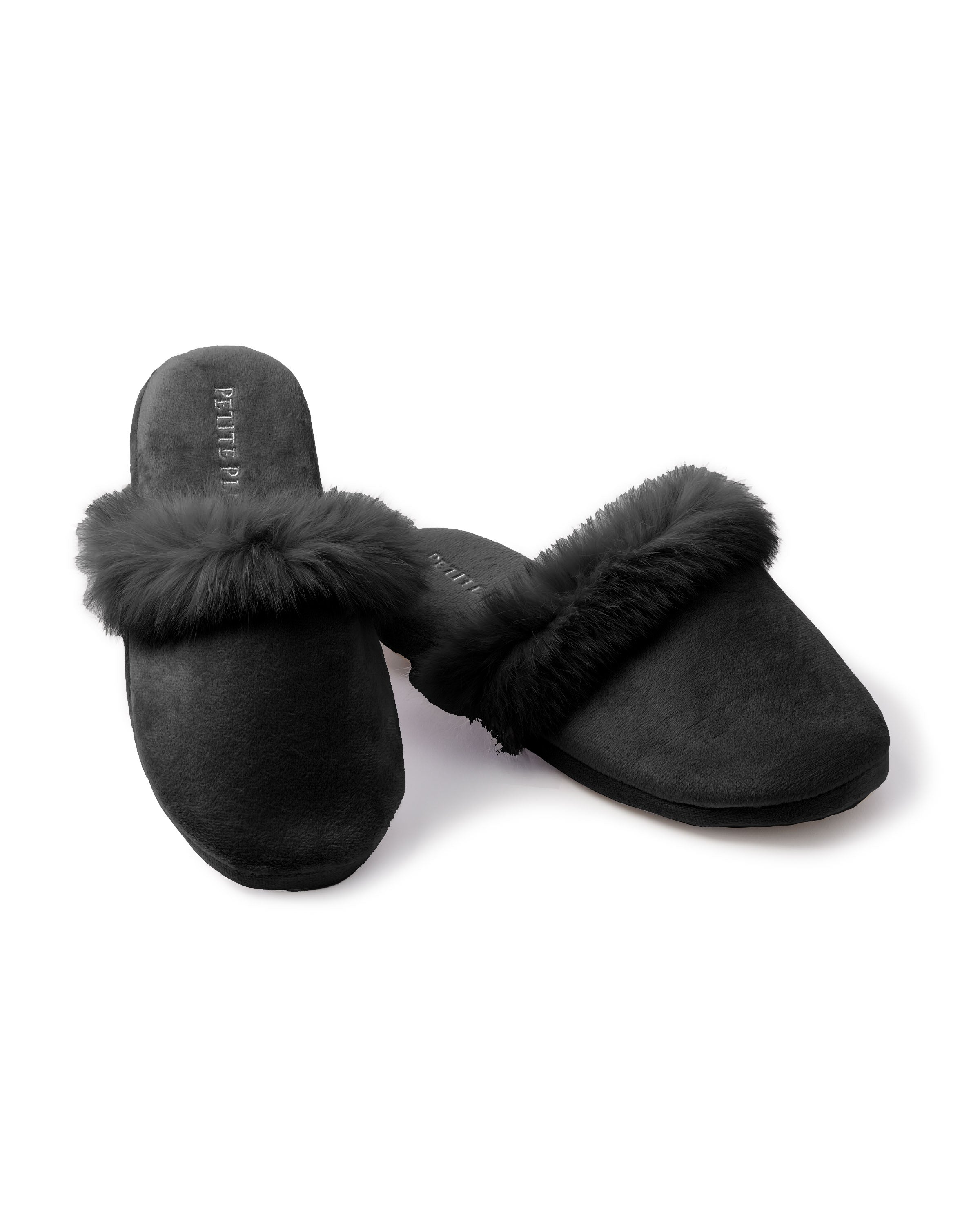 Petite Plumes Womens Faux Fur Trim Slipper in Black is a luxurious pair of slippers with plush fur trim, resting on a white background, and offering a soft, cushioned appearance perfect for any sleepwear set.