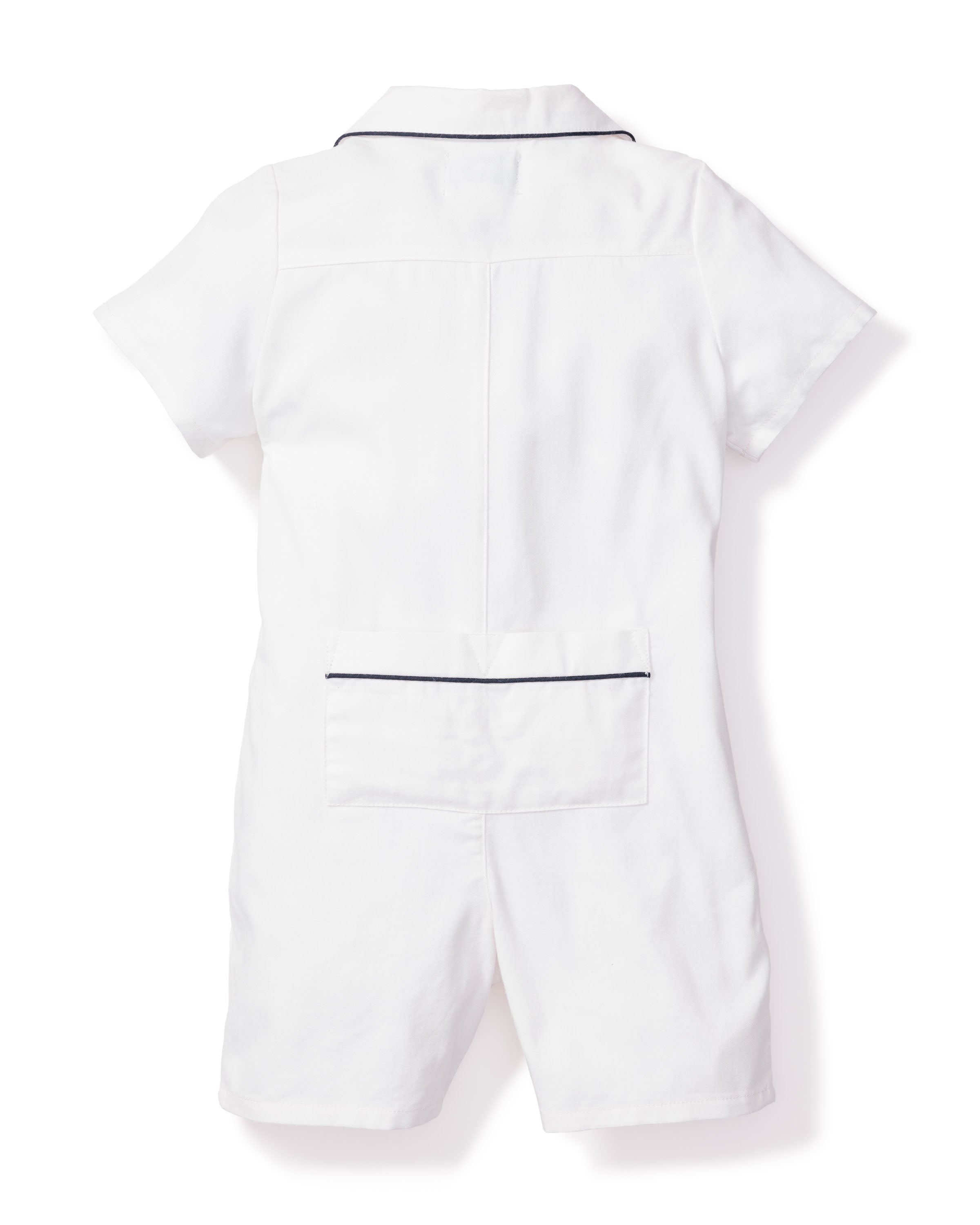 Petite Plumes Babys Twill Summer Romper in White with Navy Piping, seen from the back, made from yarn-dyed cotton. It showcases dark piping on the collar and a large lower back pocket, blending style and comfort in luxurious toddler sleepwear.