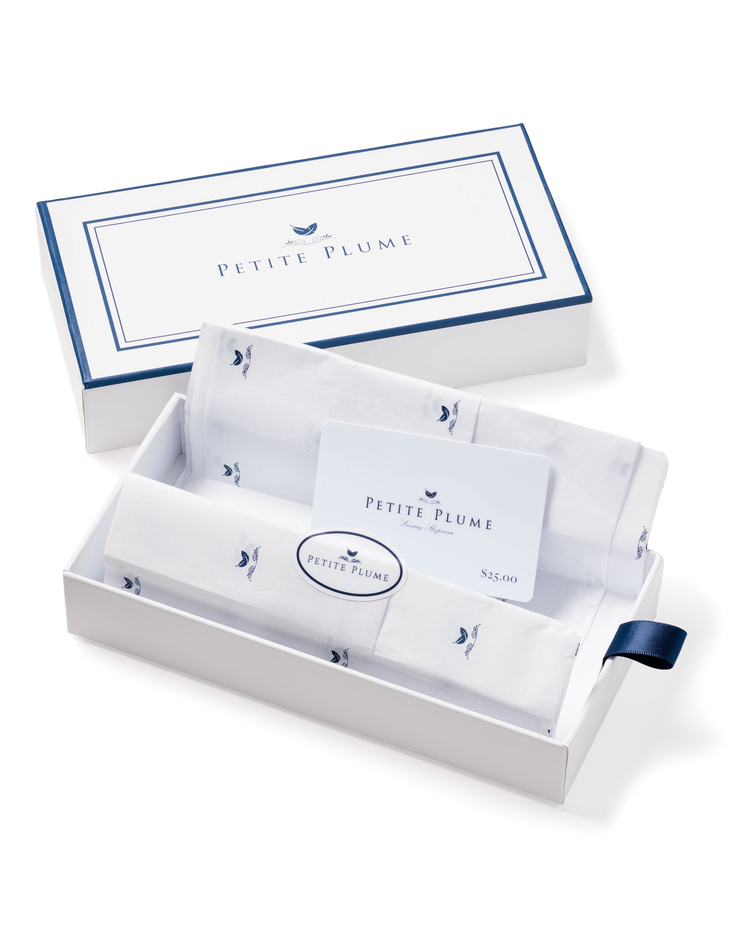 A Petite Plume gift box featuring white fabric with small blue designs, navy trim, and a navy ribbon pull tab, includes a Petite Plume Physical Gift Card. Perfect as a gift choice.