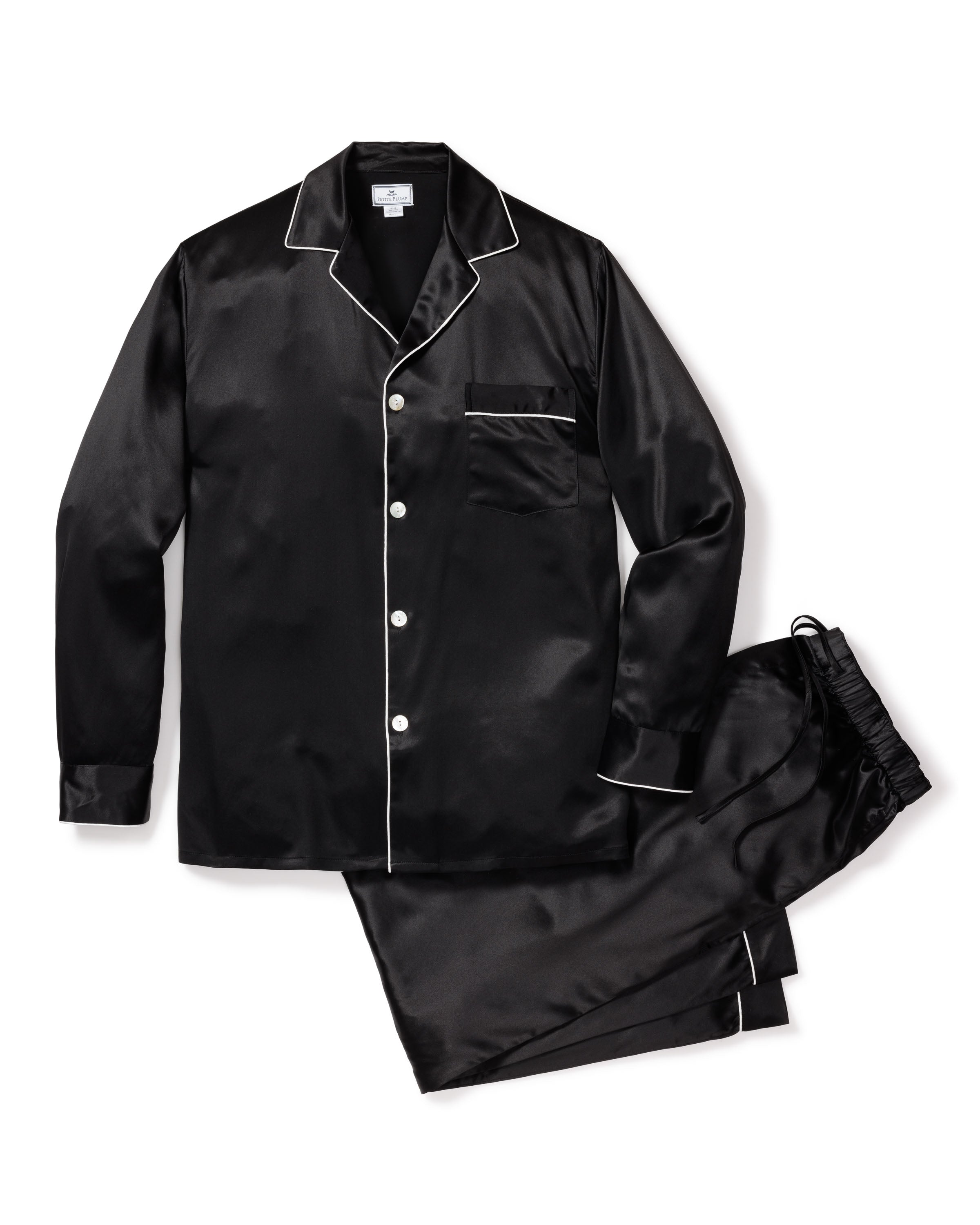 The Mens Silk Pajama Set in Black by Petite Plume is crafted from luxurious mulberry silk and features white piping. This set includes a long-sleeve button-up shirt with a chest pocket and matching elastic-waist pants, combining elegance and comfort effortlessly.
