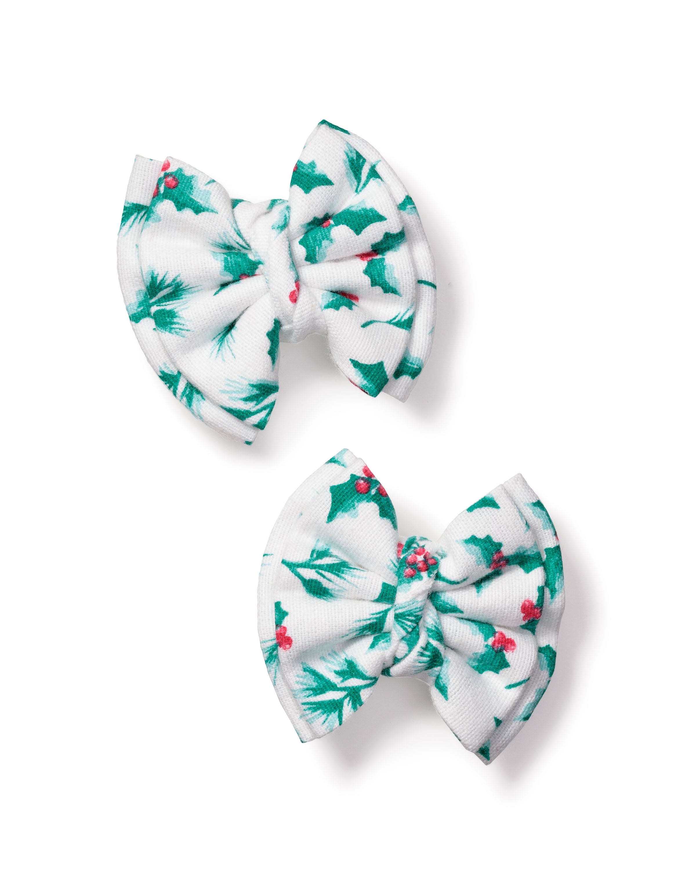 Petite Plumes Girls Hair Bows in Sprigs of the Season, featuring holly leaf and red berry designs, are beautifully set against a white background. These delightful accessories are perfect holiday gifts for girls, adding festive cheer to any hairstyle.