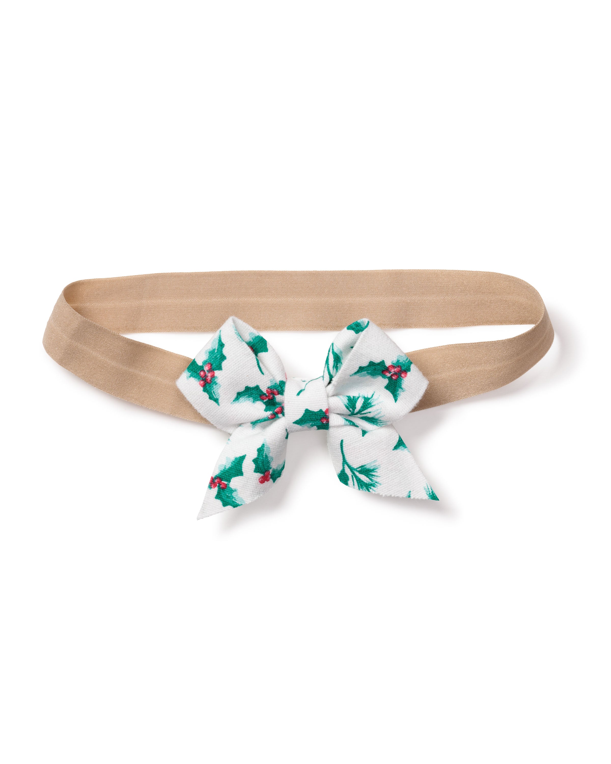 The Petite Plume Girls Hair Bows in Sprigs of the Season is a charming beige headband featuring a centrally attached white bow adorned with green holly leaves and red berries, making it an ideal festive gift for those who love holiday-themed hair accessories.