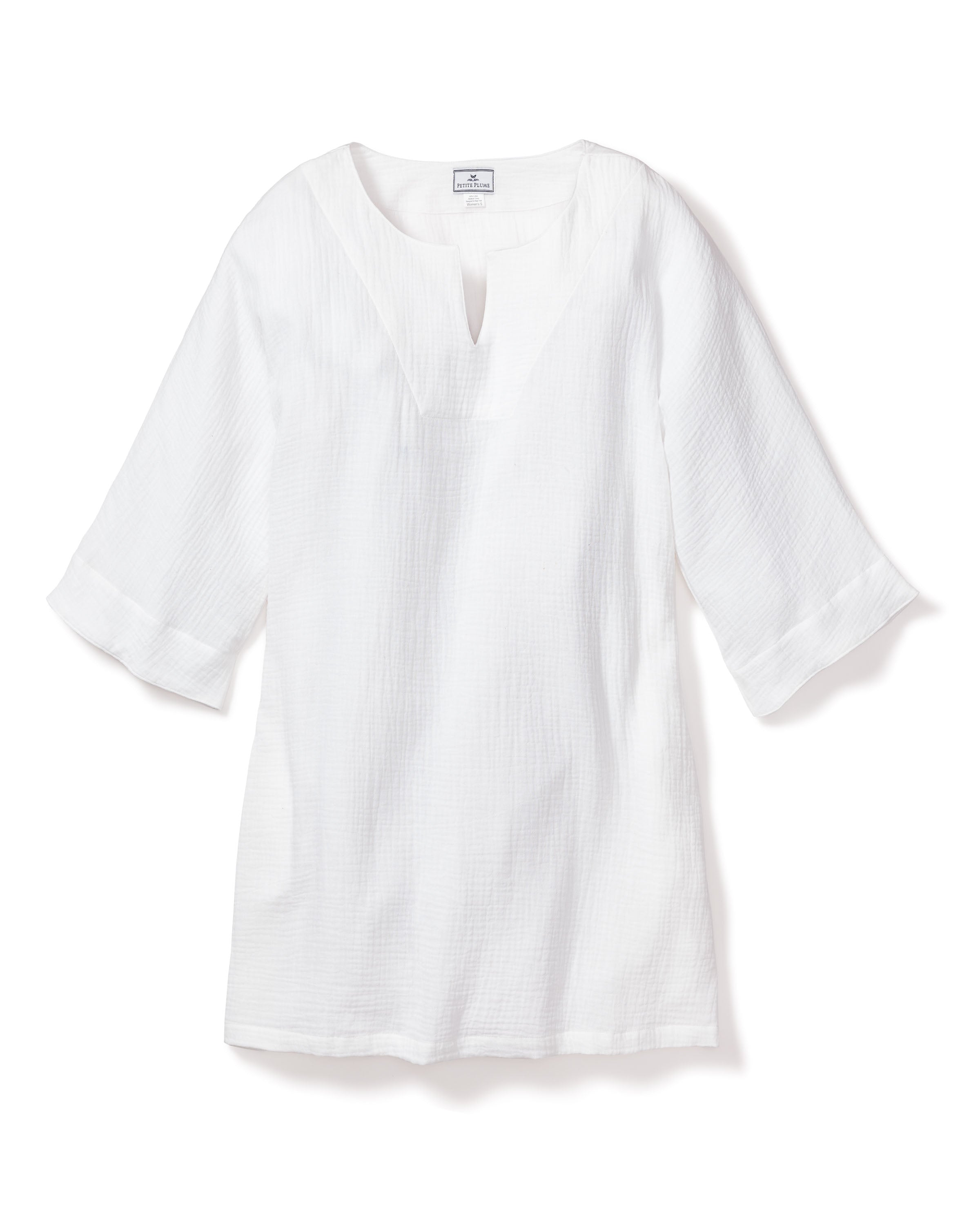 The Womens Gauze Short Caftan in White by Petite Plume is a simple, lightweight tunic made from textured cotton gauze fabric with long sleeves and a notched neckline, ideal for casual wear.