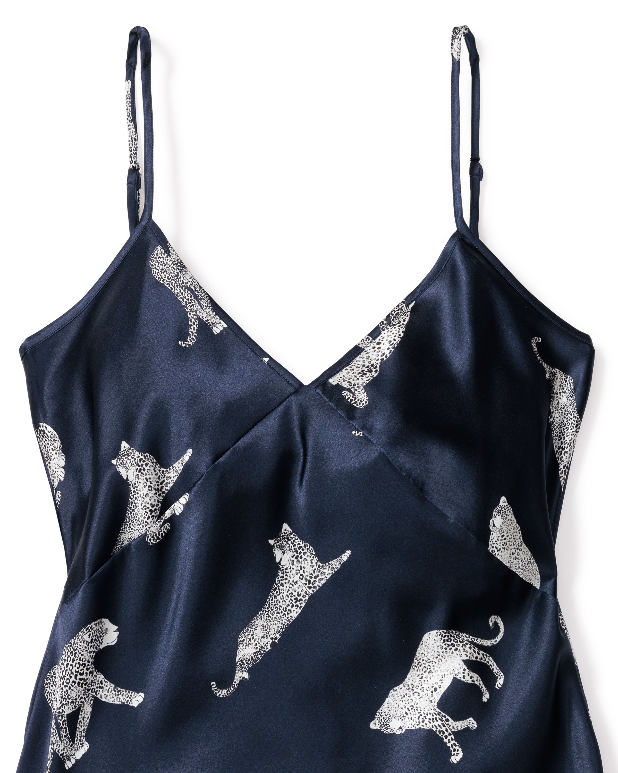 The Petite Plume Womens Silk Cami Short Set in Panthère de Nuit features navy blue spaghetti straps, a V-neck, and white leopards on mulberry silk for an elegant style.