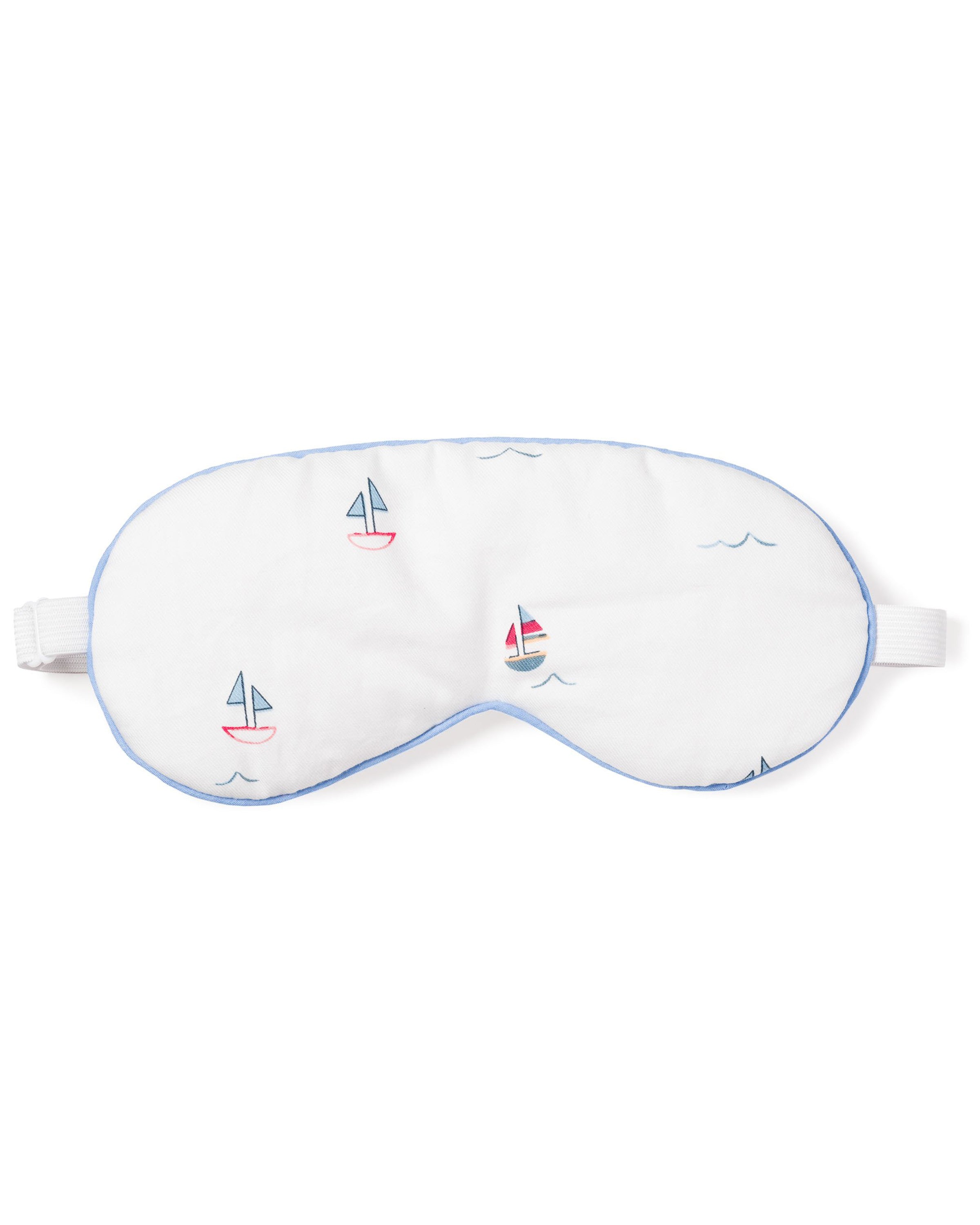 The Adults Twill Sleep Mask in Bateau by Petite Plume is a white mask with light blue trim and colorful sailboat designs. It has an adjustable strap for a luxurious sleep experience and makes a perfect monogrammed gift for those who appreciate elegance at bedtime.