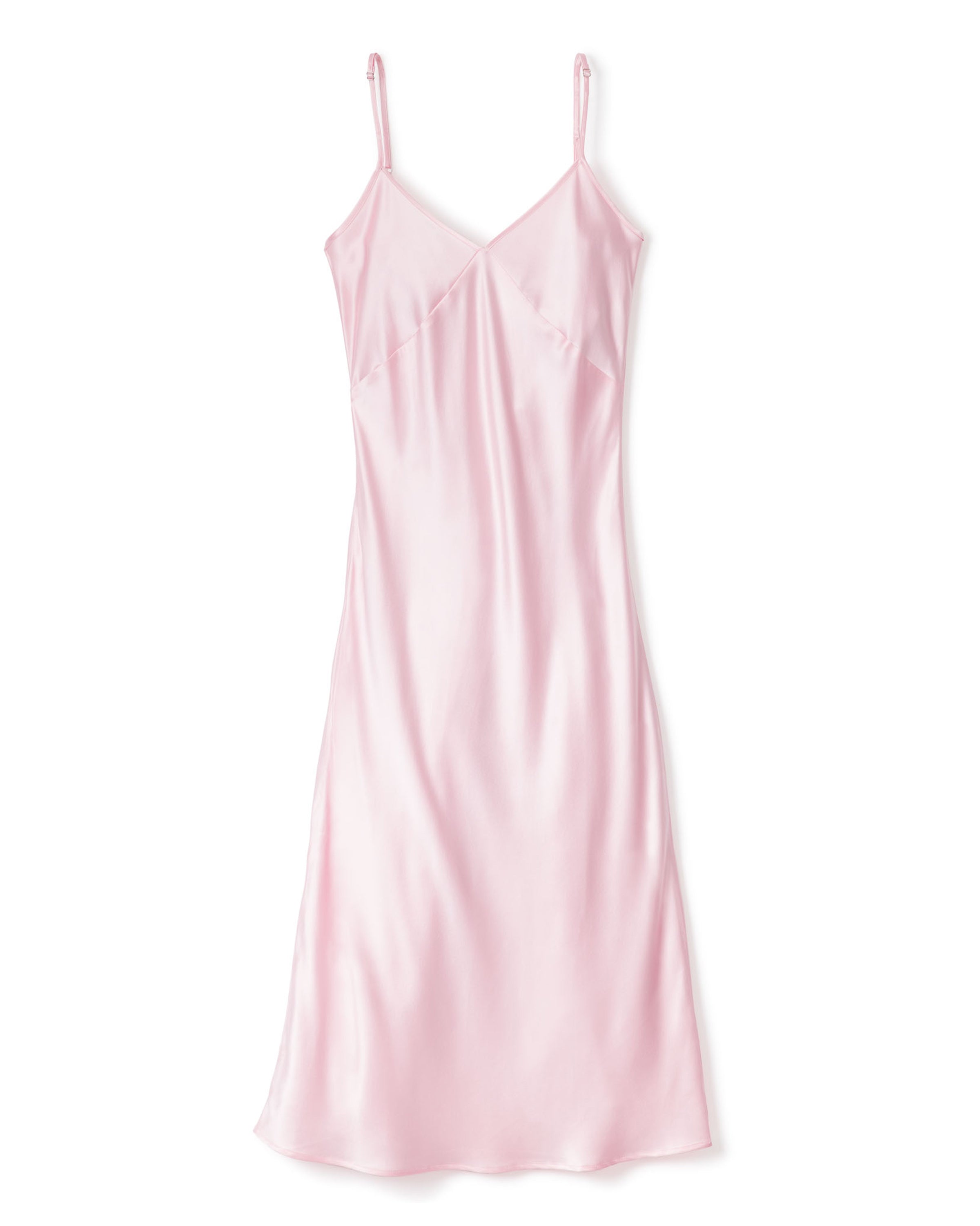 The Petite Plume Womens Silk Cosette Nightgown in Pink features a sleeveless, knee-length design with thin spaghetti straps and a V-neckline, offering a luxurious look reminiscent of silk sleepwear. The smooth, shiny fabric enhances its simple and elegant silhouette for any occasion.