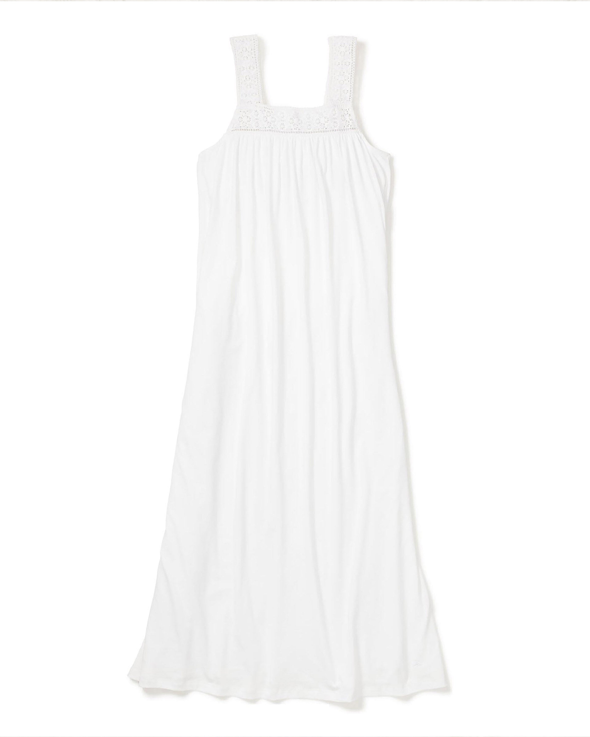 The Womens Pima Camille Nightgown in White by Petite Plume offers wide straps and a gathered bodice. Crafted from lightweight Peruvian Pima cotton, it flows elegantly on a plain white backdrop, exuding simplicity and charm.