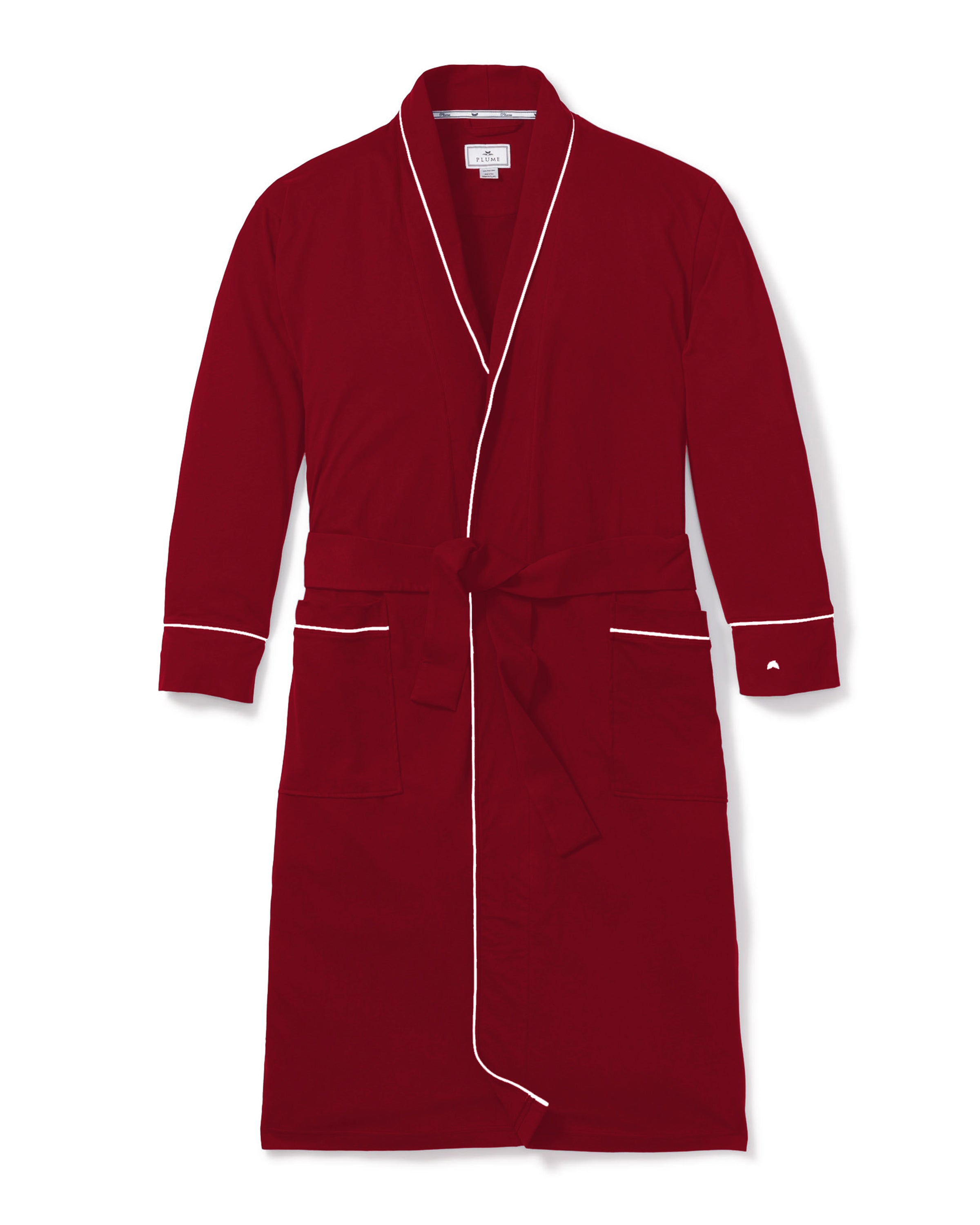 The Mens Pima Robe in Bordeaux by Petite Plume is crafted from plush Peruvian Pima cotton. This red robe with white piping features two front pockets and a matching belt, echoing classic pajama silhouettes.
