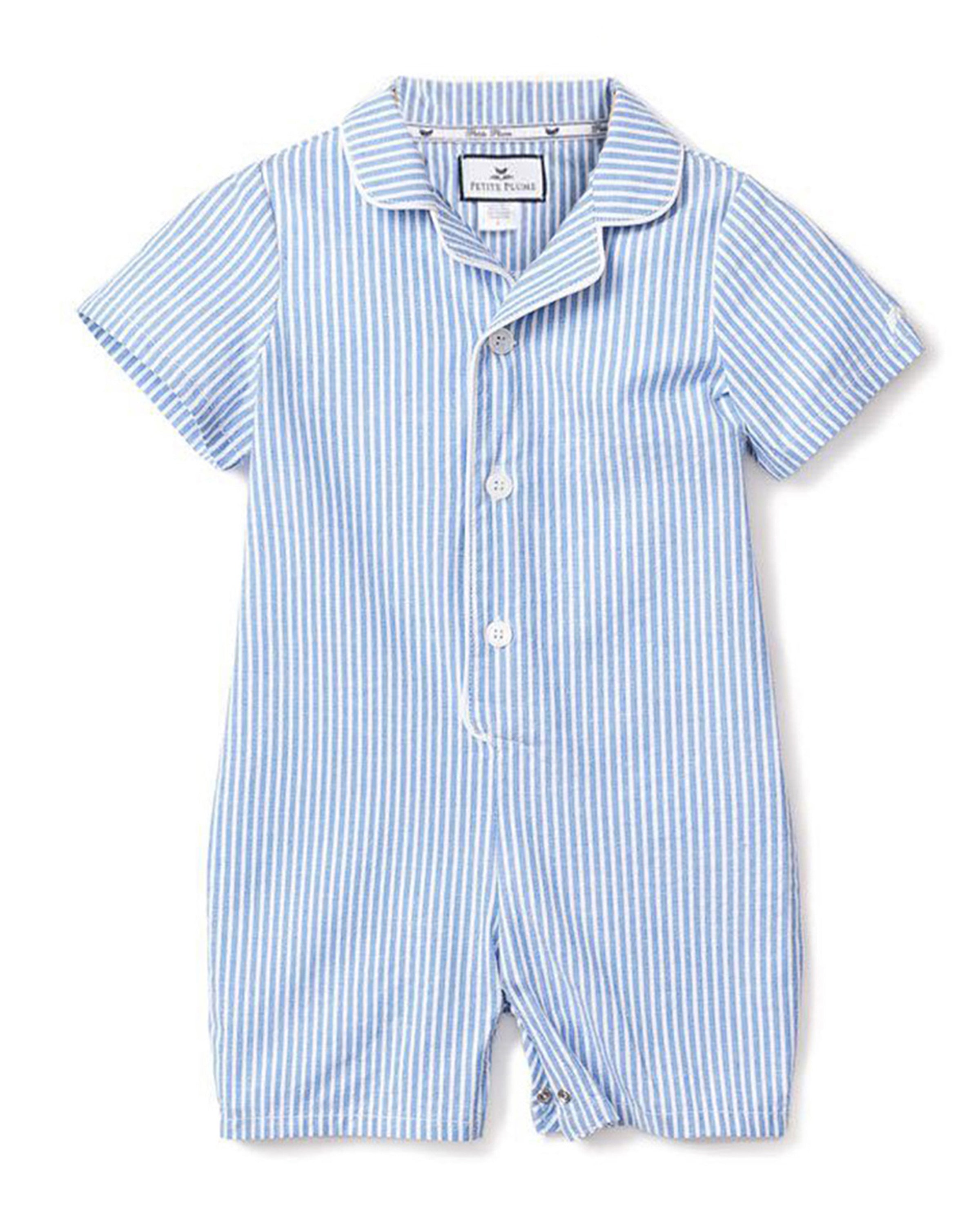 The Petite Plume Babys Twill Summer Romper in French Blue Seersucker features short sleeves, a collar, and front buttons. Made from lightweight seersucker fabric, its perfect for keeping your little one cool and comfortable.