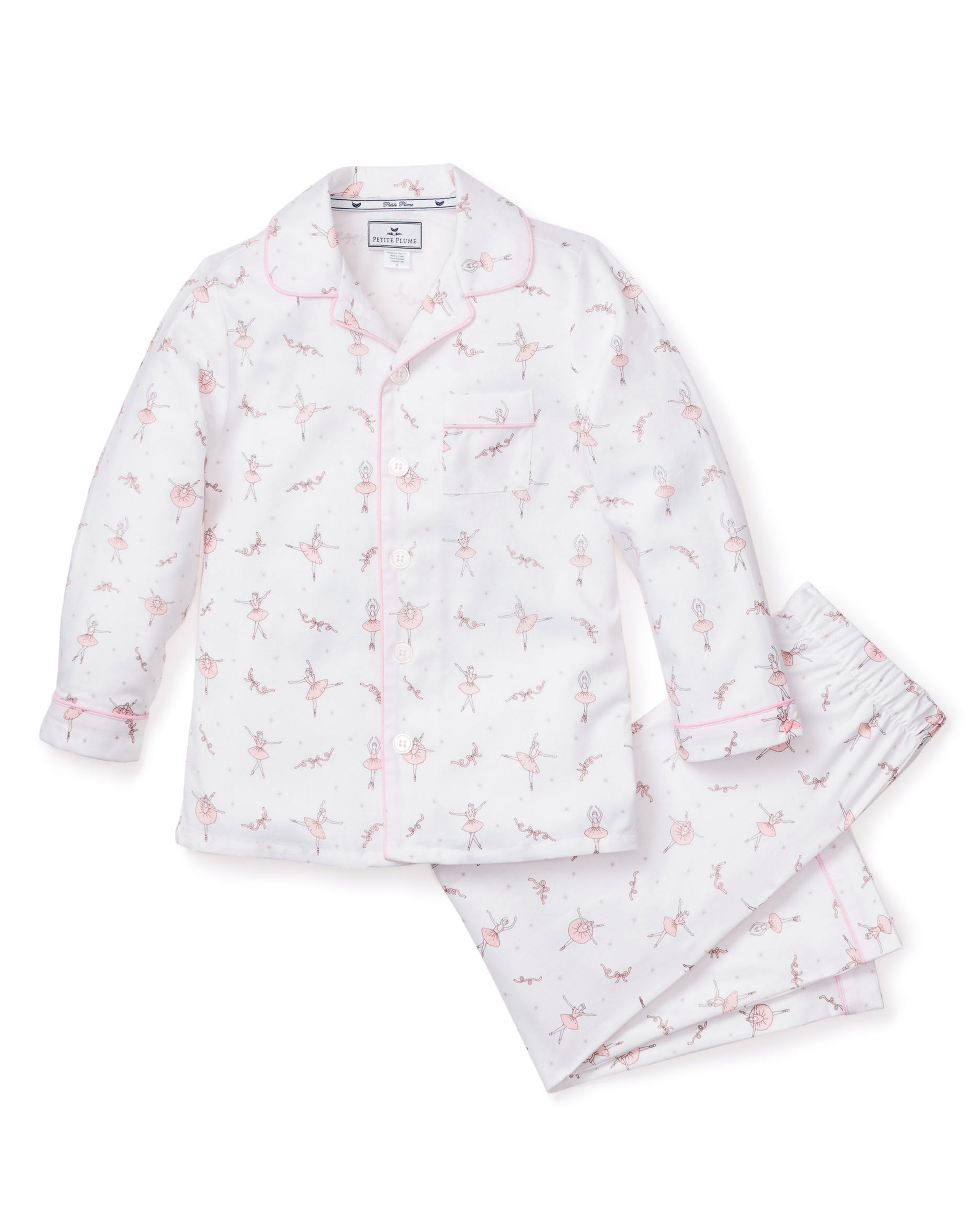 Petite Plumes Kids Twill Pajama Set in Sugar Plum Fairy features a white pajama set with pink piping and ballerina print. Crafted from premium cotton, it includes a long-sleeve button-up top with a chest pocket and matching elastic waistband pants, adorned with delicate ballerina illustrations.