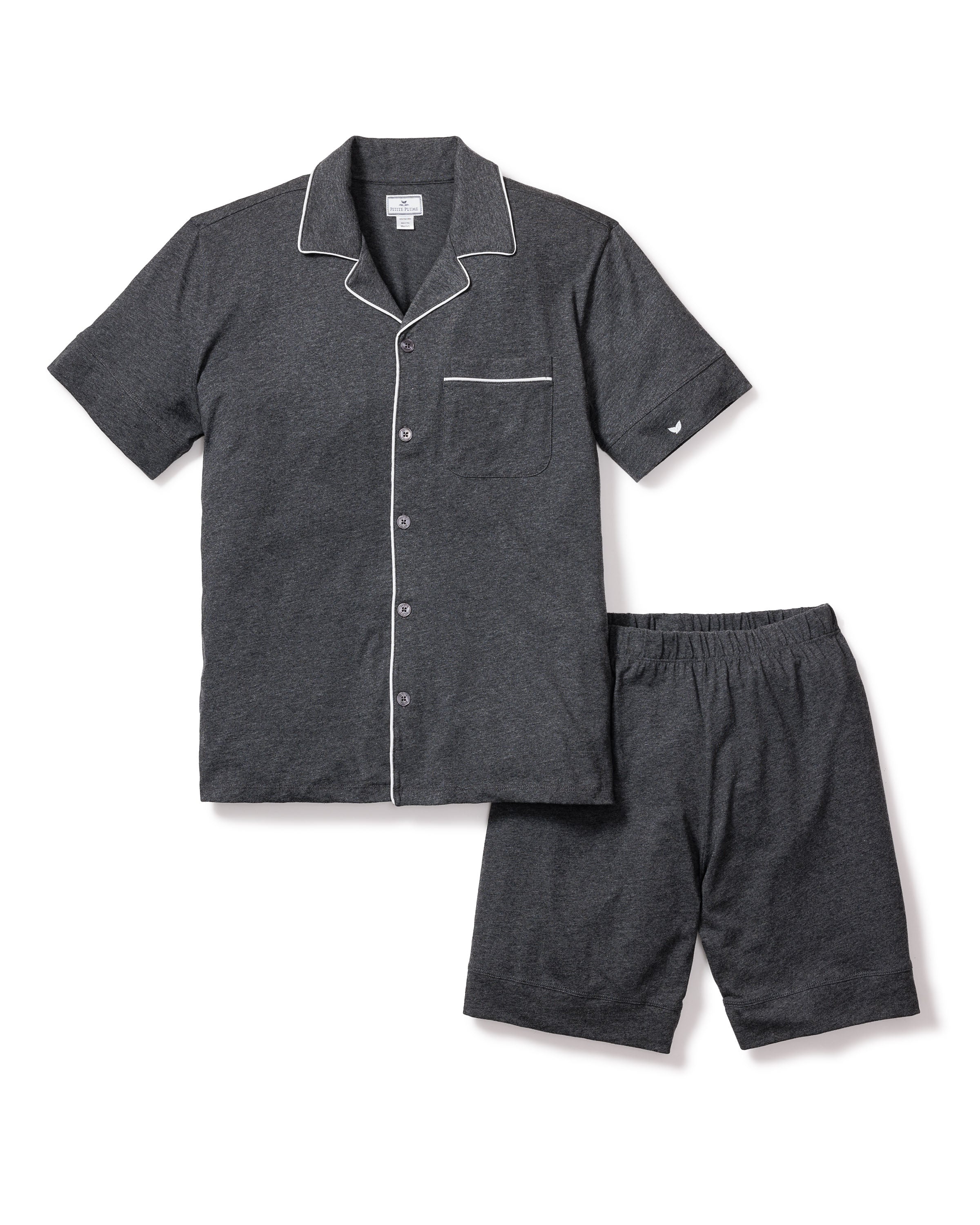 The Mens Pima Pajama Short Set in Dark Heather Grey by Petite Plume is made from soft jersey knit. It features a short-sleeve button-up top with a chest pocket and white piping, paired with shorts that have an elastic waistband for comfort, crafted from quality yarn-dyed fabric.