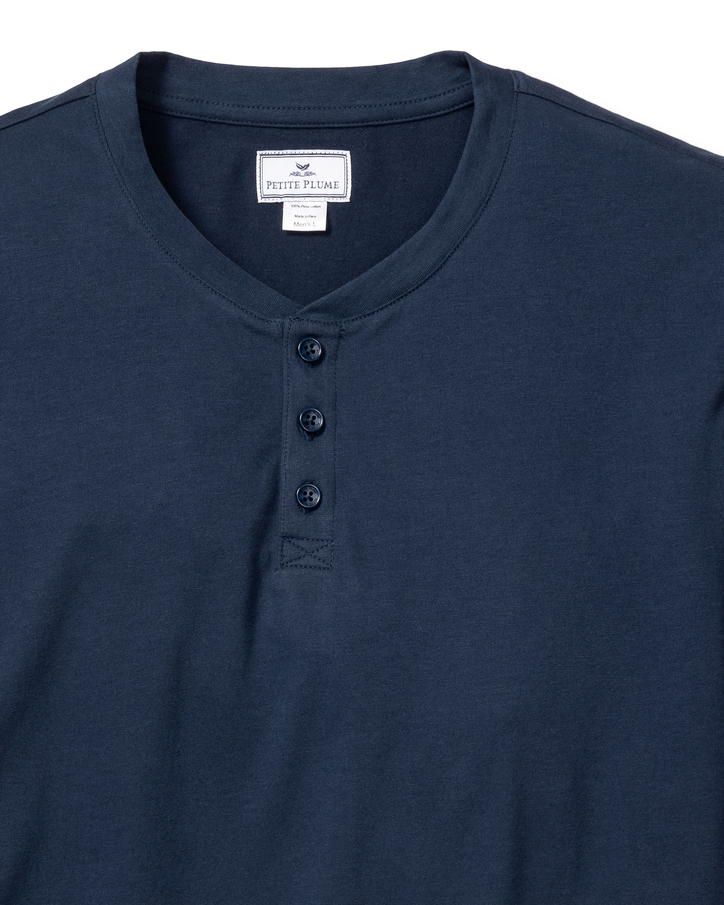 The Mens Pima Henley in Navy by Petite Plume features a soft Peruvian Pima cotton fabric and a classic three-button placket. Its simple design makes it an ideal addition to your bedtime routine, displayed on a white background for clarity.