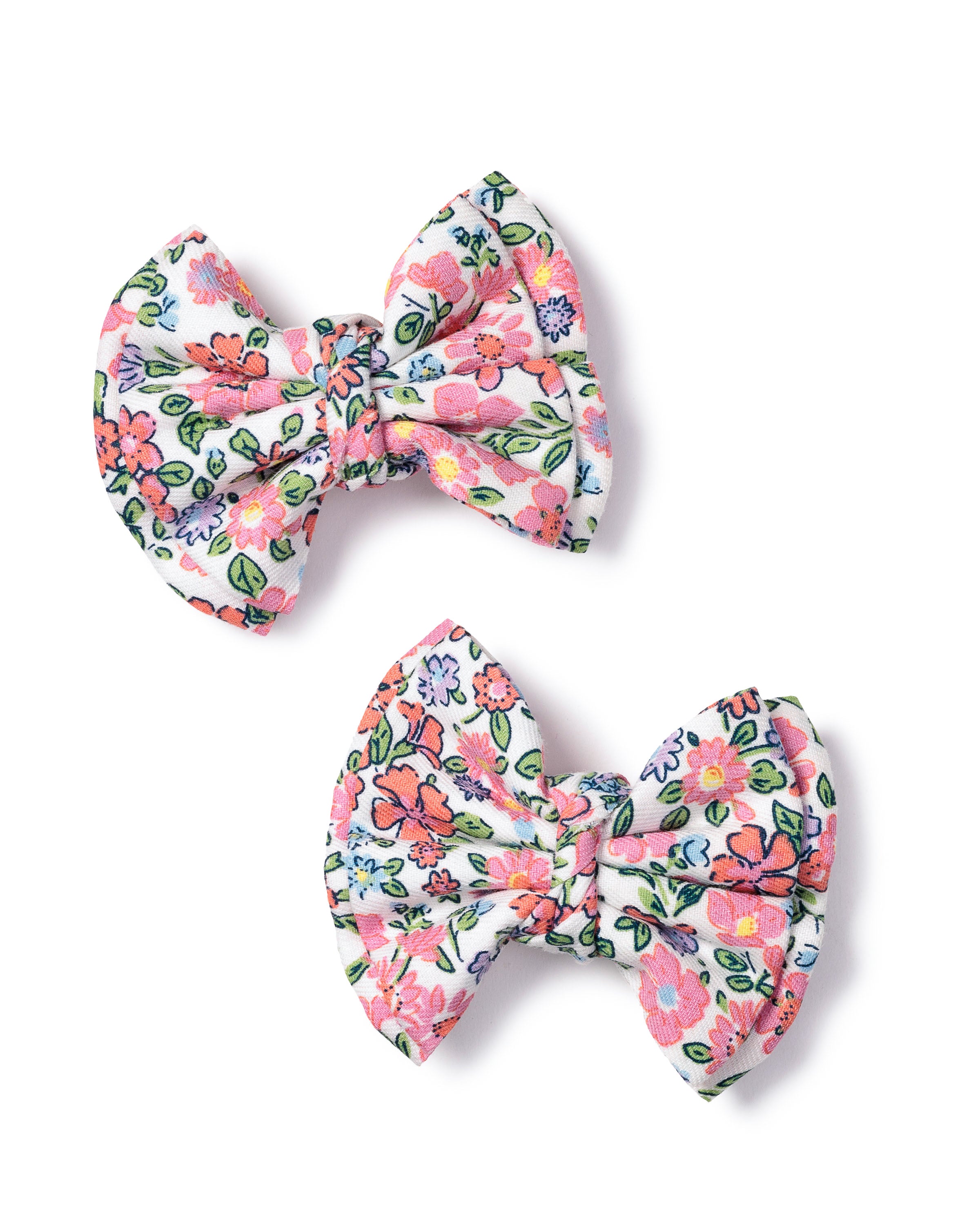 Two fabric hair bows from Petite Plume, called Girls Hair Bows in Fleurs de Rose, are the perfect accessory with a colorful floral pattern on a white background featuring pink, red, and blue flowers with green leaves arranged diagonally.