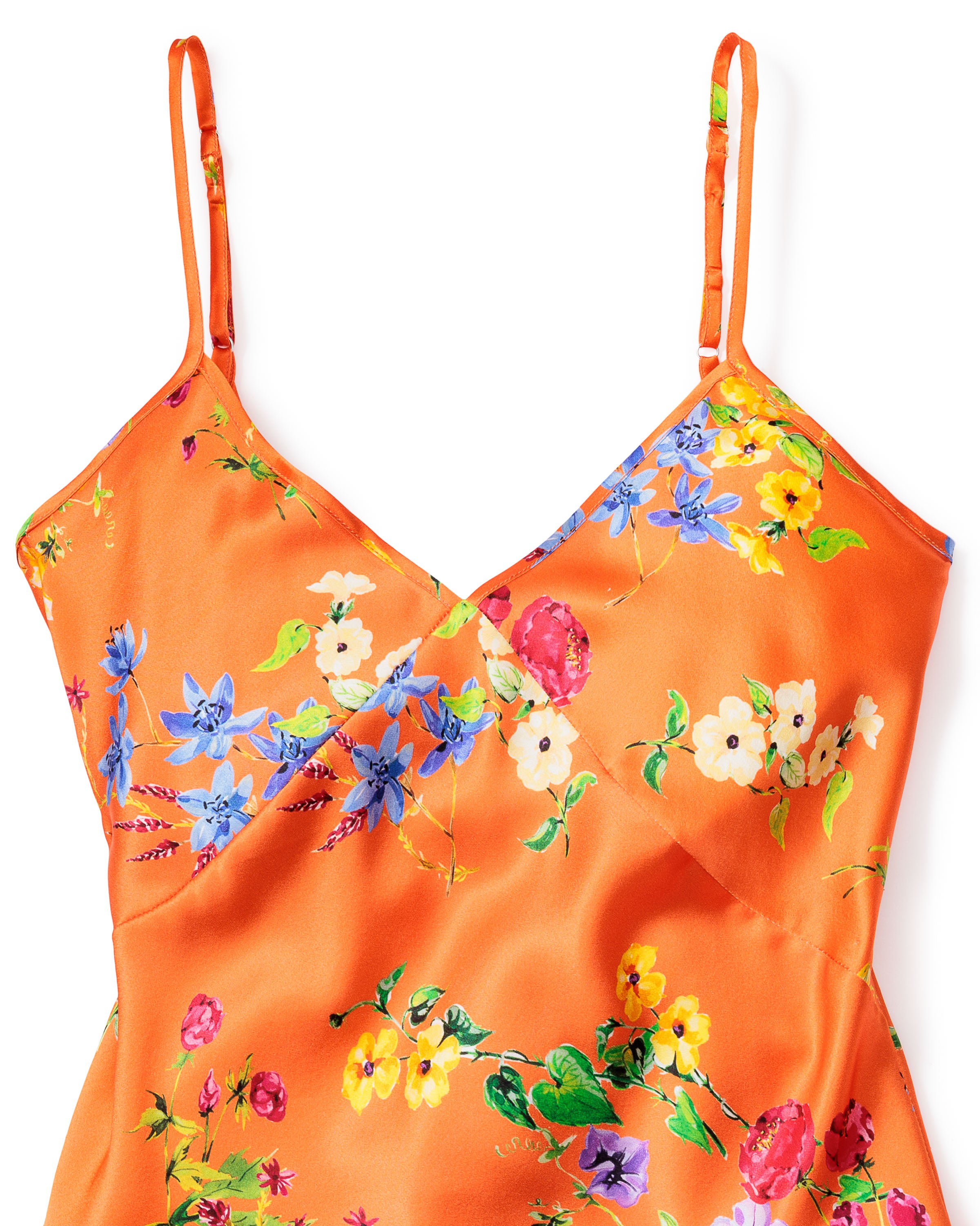 This luxurious Womens Silk Cami Short Set by Petite Plume, in Tangerine Brilliant Botanical, features a V-neckline and thin straps. The silk fabric is adorned with colorful flowers, including blue, yellow, pink, and white blossoms.