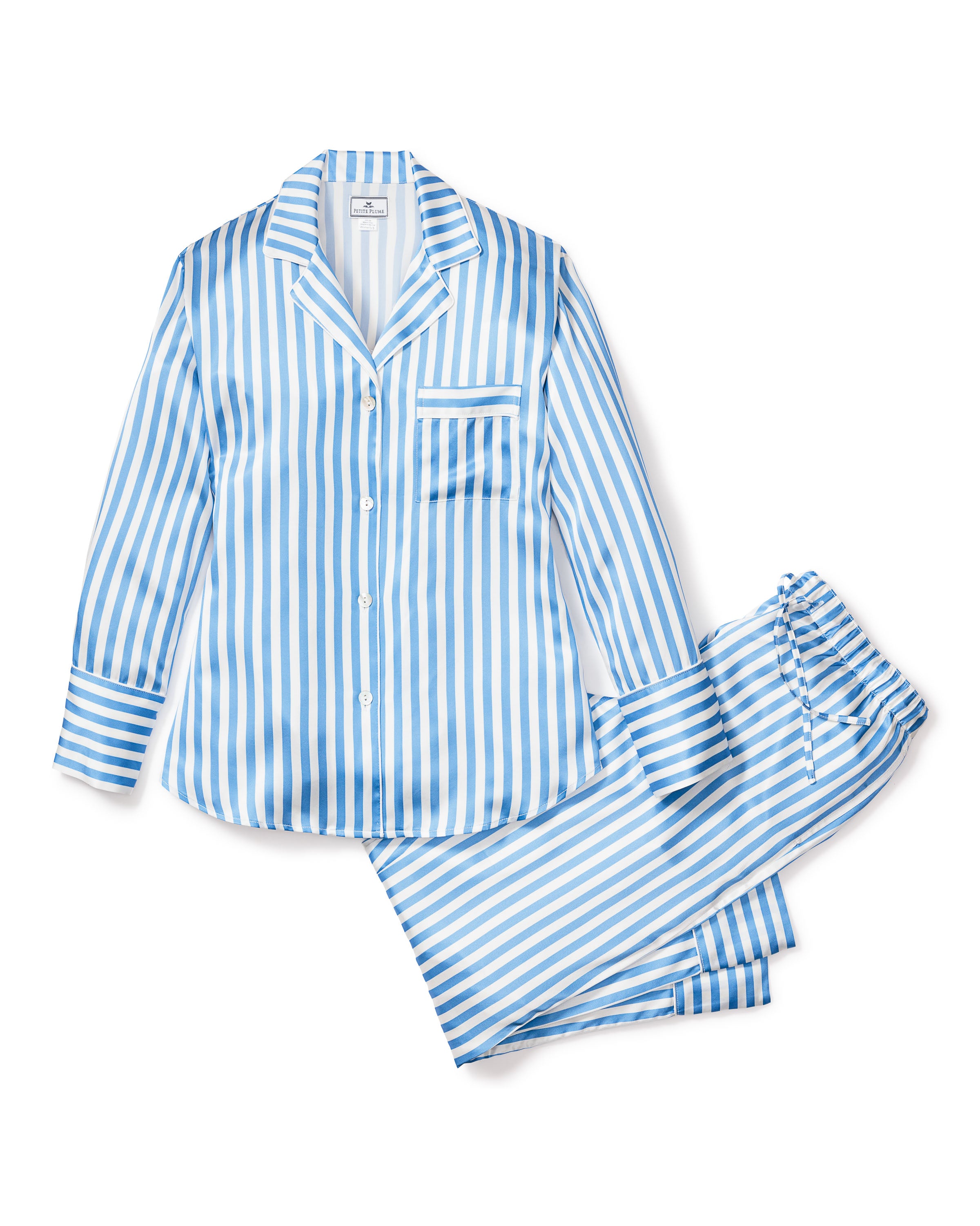 Petite Plumes Womens Silk Pajama Set in Azure Stripe features luxurious blue and white vertical stripes with a long-sleeved button-up shirt, a left front pocket, and drawstring pants. The silky fabric ensures a smooth finish for blissful nighttime comfort.