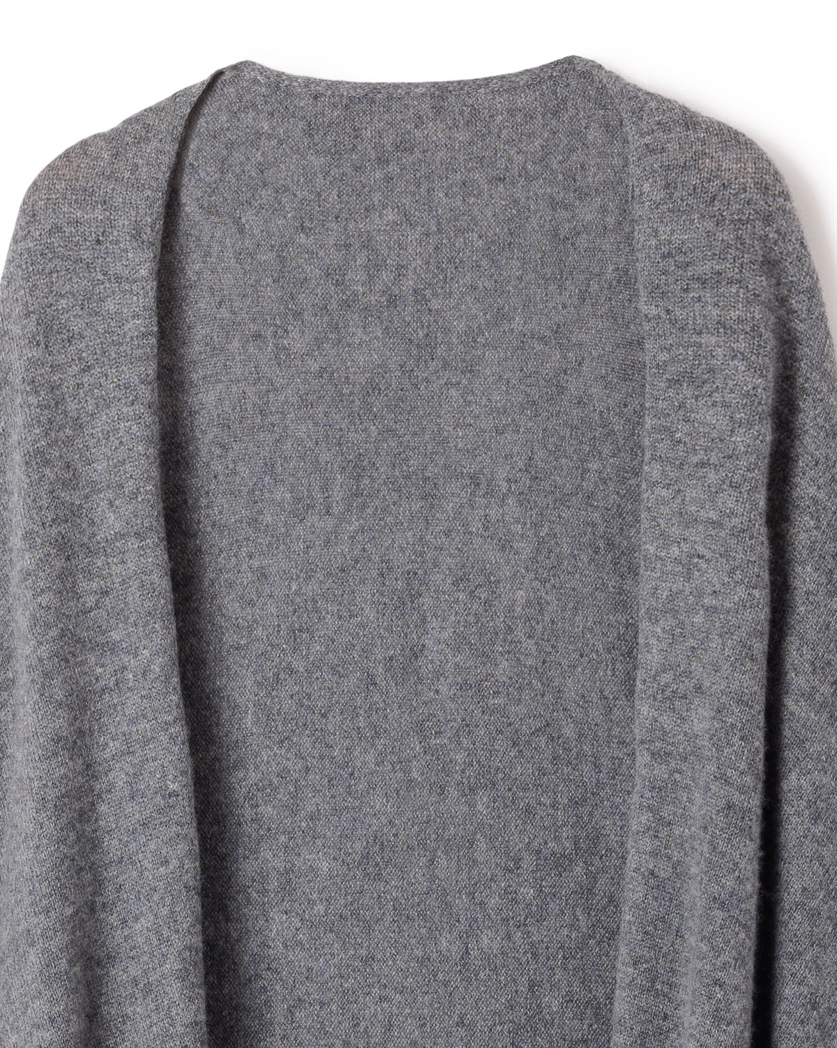 Close-up of a Petite Plume Womens Cashmere Wrap in Dark Grey, exuding luxurious warmth with its textured surface. The wrap looks soft and inviting, reminiscent of cozy garments. The plain white background enhances its tactile allure.