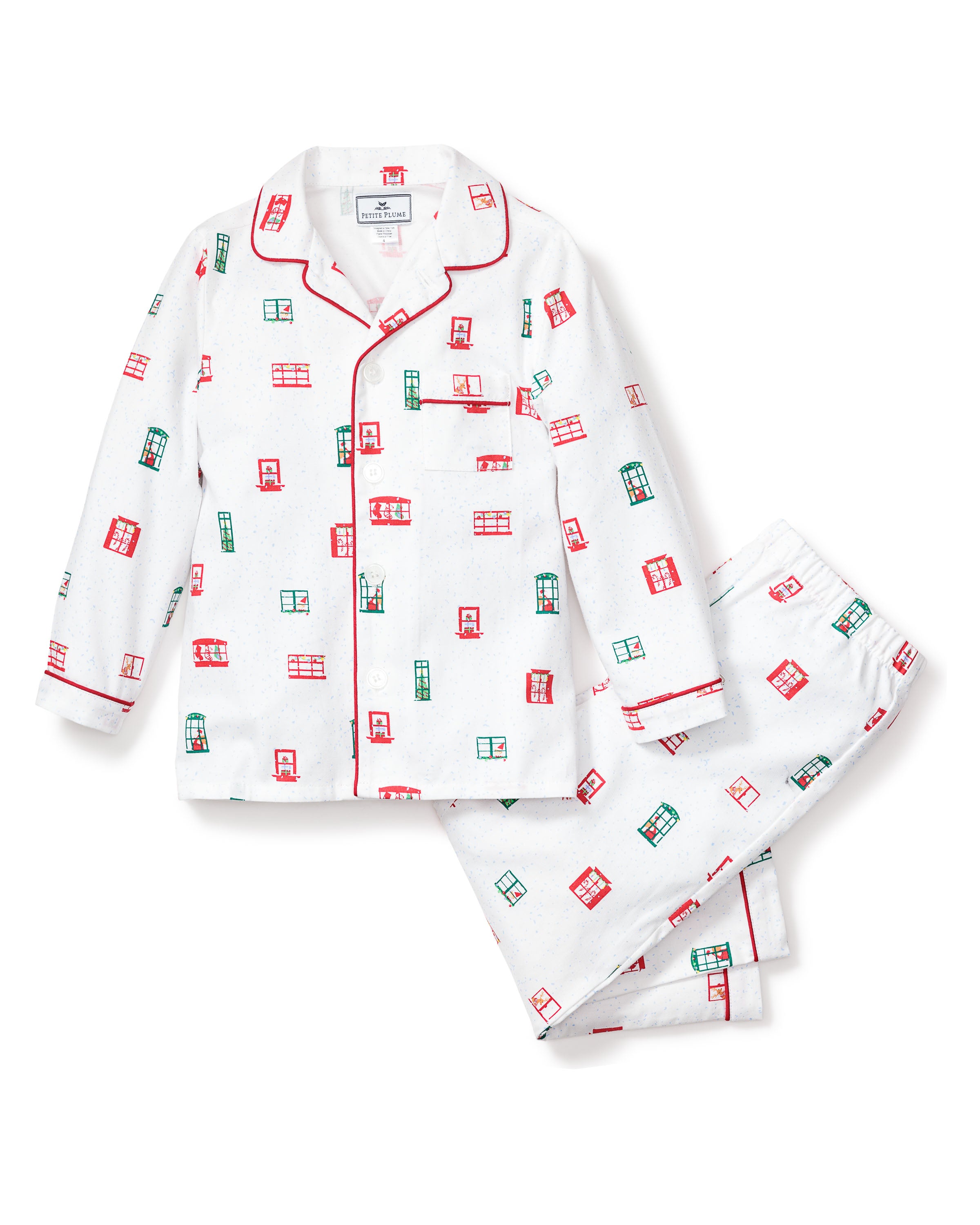 The Kids Maisonette x Petite Plume Night Before Pajama Set by Petite Plume is a classic twill sleepwear featuring a button-up shirt and pants with red and green geometric patterns, a collar, and red piping details inspired by the Night Before Christmas print.