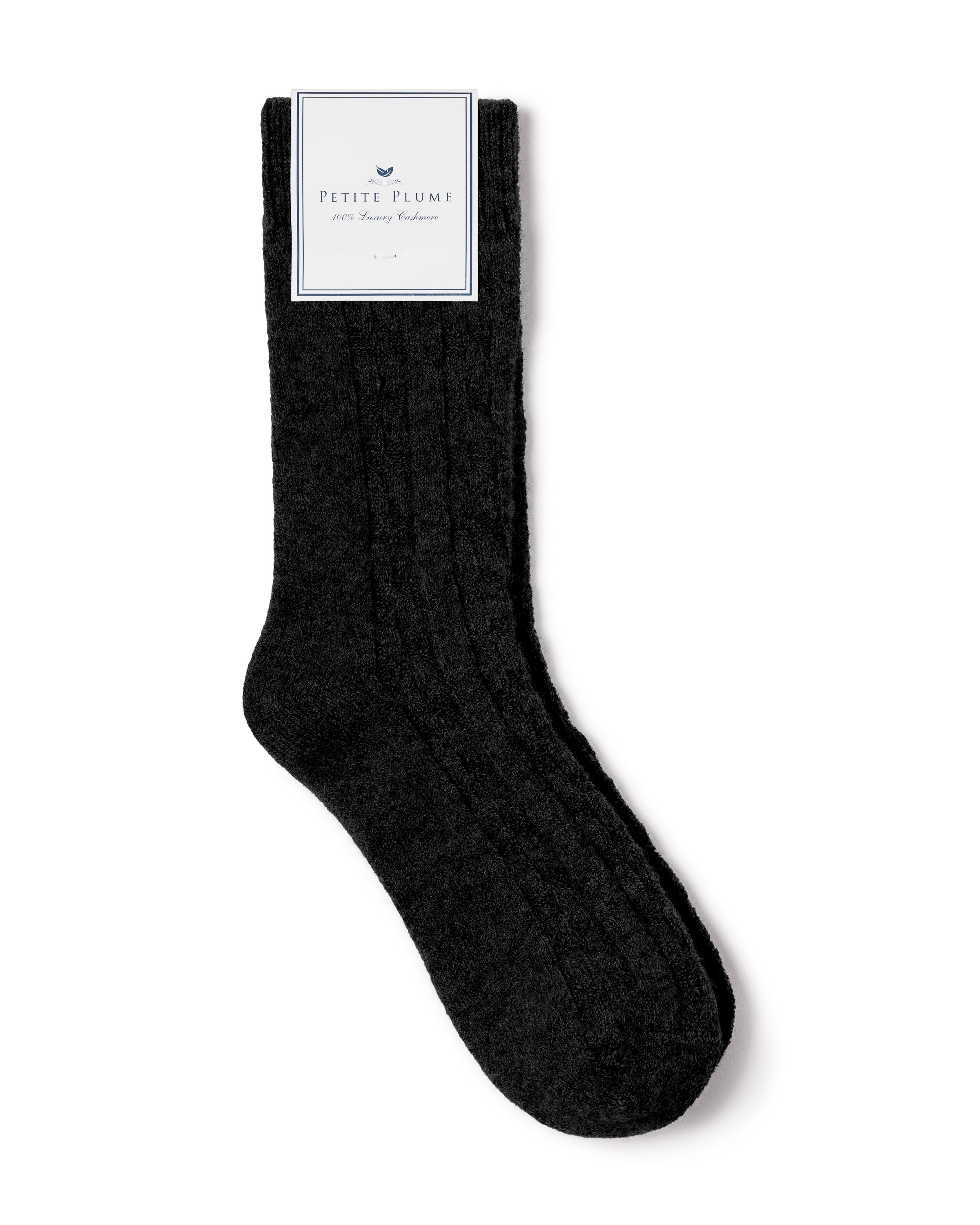 The Womens Cashmere Sock in Black by Petite Plume boasts Grade A Cashmere for plush texture and luxurious comfort, with the brand label near the top. Elegantly displayed on a white background.