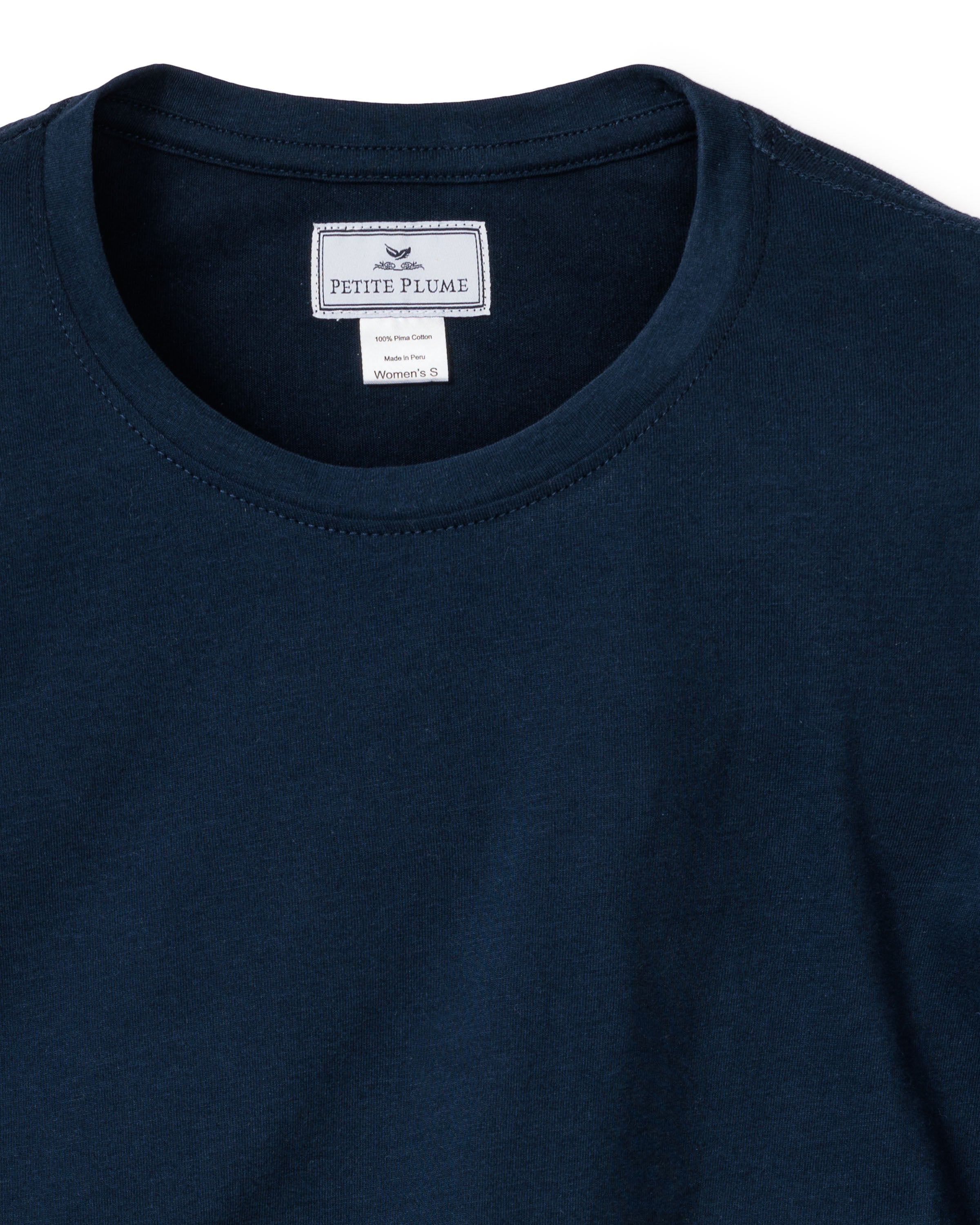 A Womens Pima Long Sleeve Top in Navy from the Petite Plume brand is displayed on a white background. The back neck label indicates its crafted from Peruvian Pima cotton and is size Womens Small.
