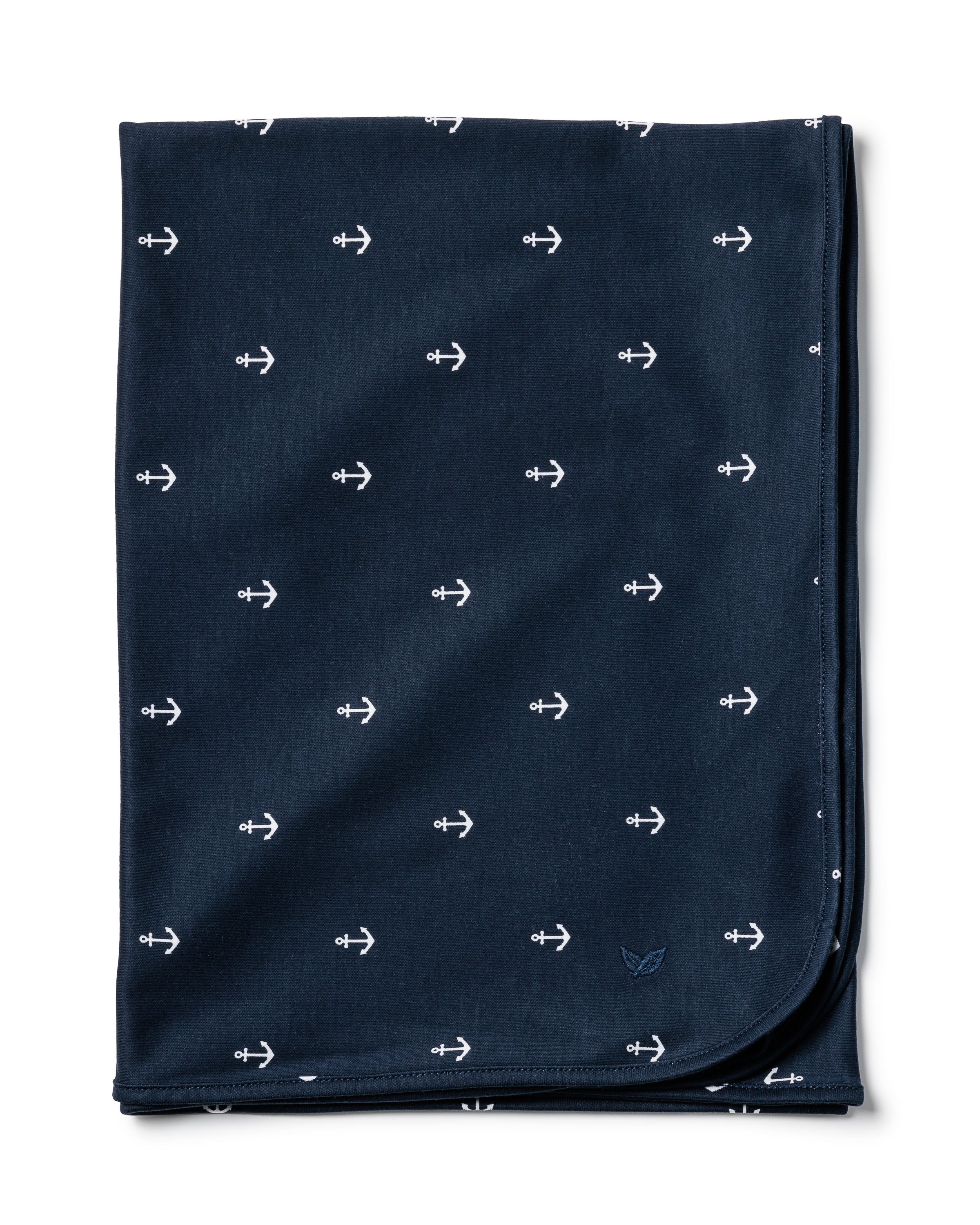 The Pima Baby Blanket in Portsmouth Anchors by Petite Plume is a folded, dark blue baby blanket crafted from cozy Peruvian Pima Cotton. It features a uniform pattern of small white anchors and slightly rounded corners for comfort and lightweight warmth.