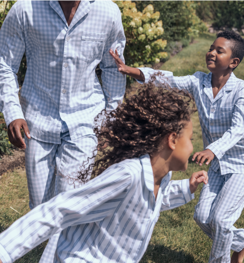Children running and playing in white and blue pajamas outside