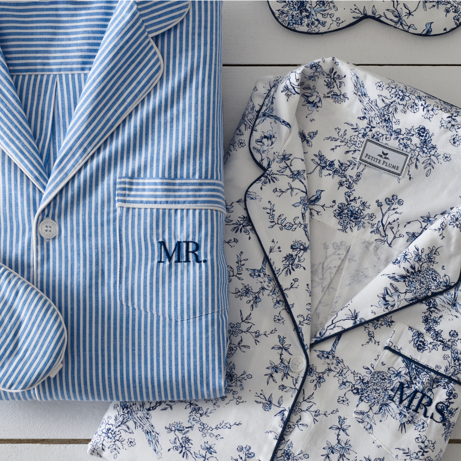 Folded blue and white pajamas. The pockets has MR and MRS monogrammed on the pockets