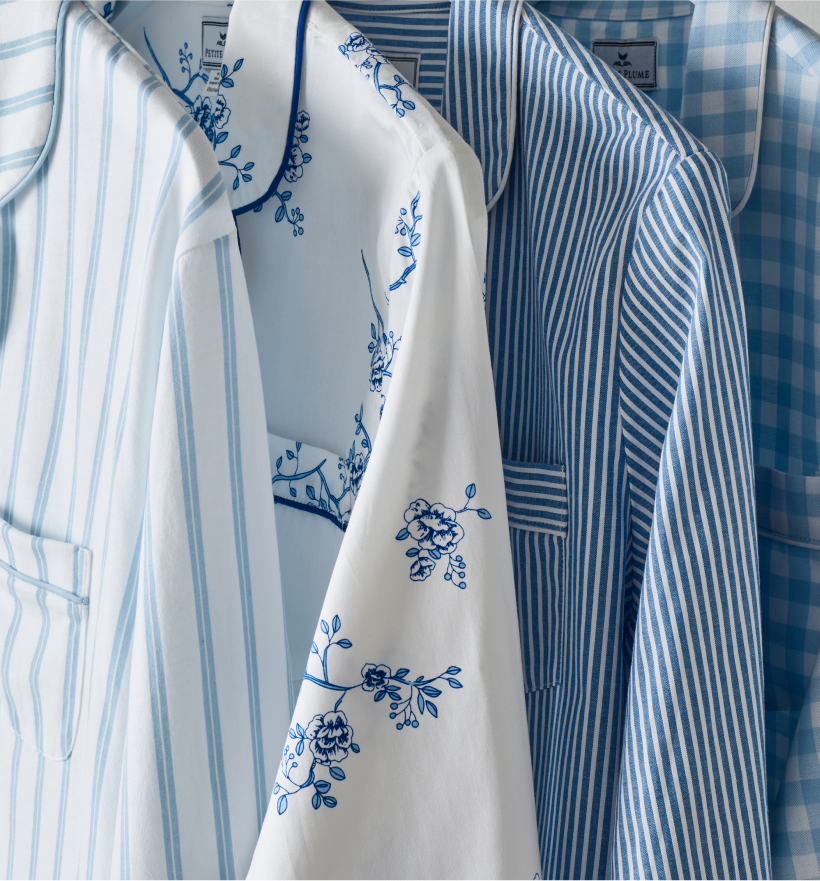 Blue and white pajama tops hanging in a row