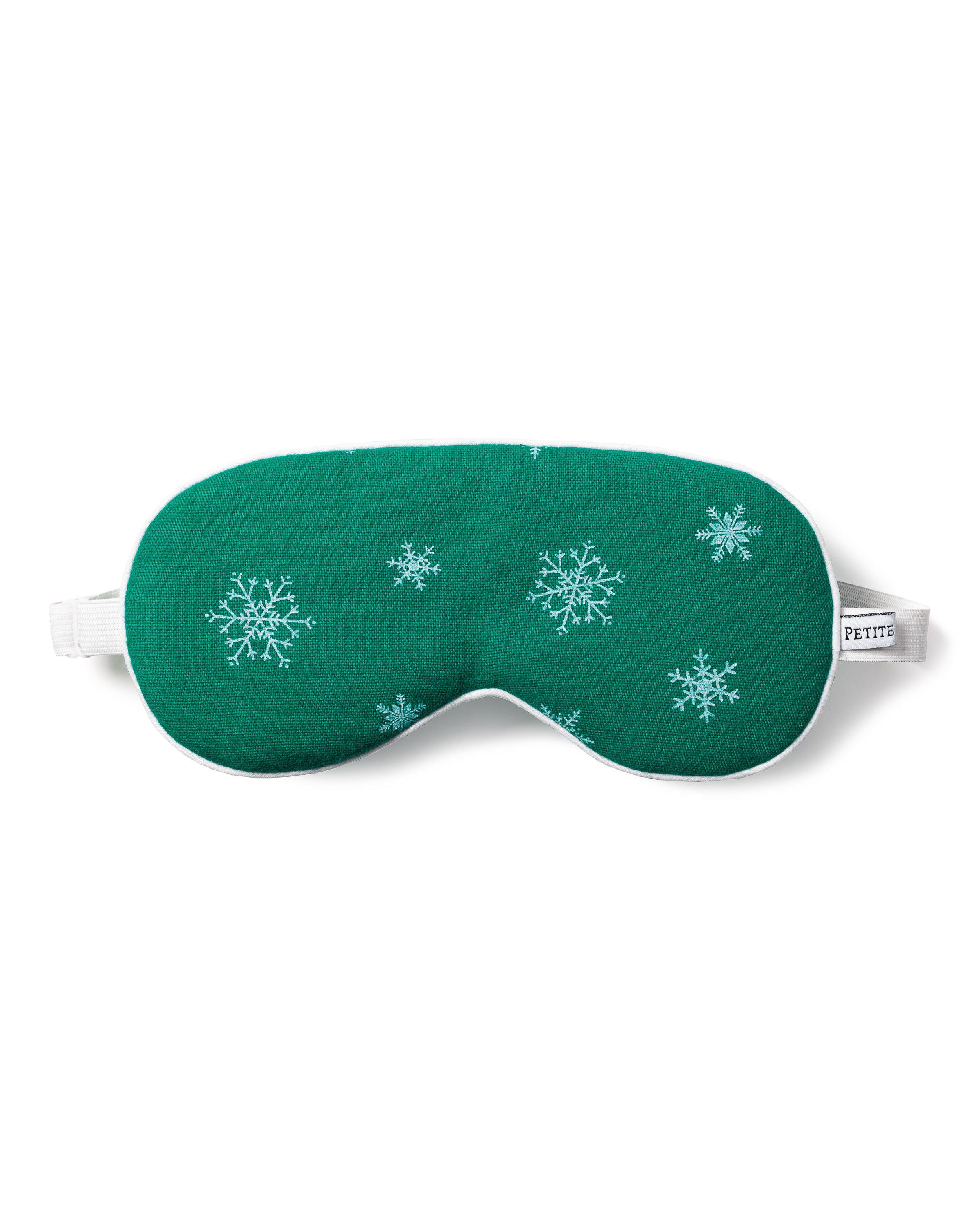 The Adults Flannel Sleep Mask in Emerald Wonderland by Petite Plume is a perfect gift, featuring green fabric with white snowflake patterns and a white elastic strap on each side. The PETITE label ensures easy matching with other eye masks.