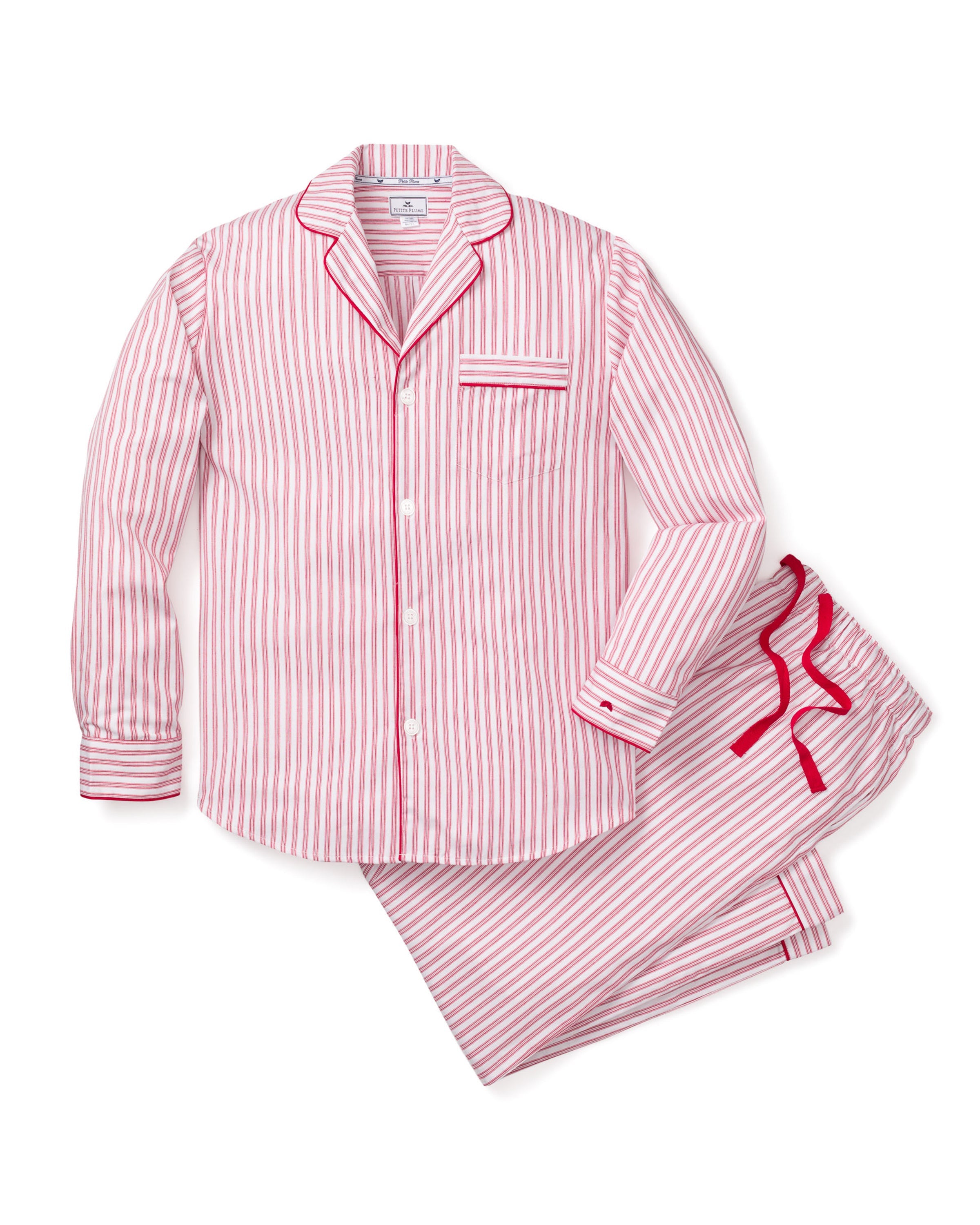 The Mens Twill Pajama Set in Antique Red Ticking by Petite Plume features red and white stripes, a button-up long-sleeve top with a chest pocket and red piping, and matching drawstring pants. Made from 100% cotton twill with moisture-wicking weave, its light and perfect for comfort.