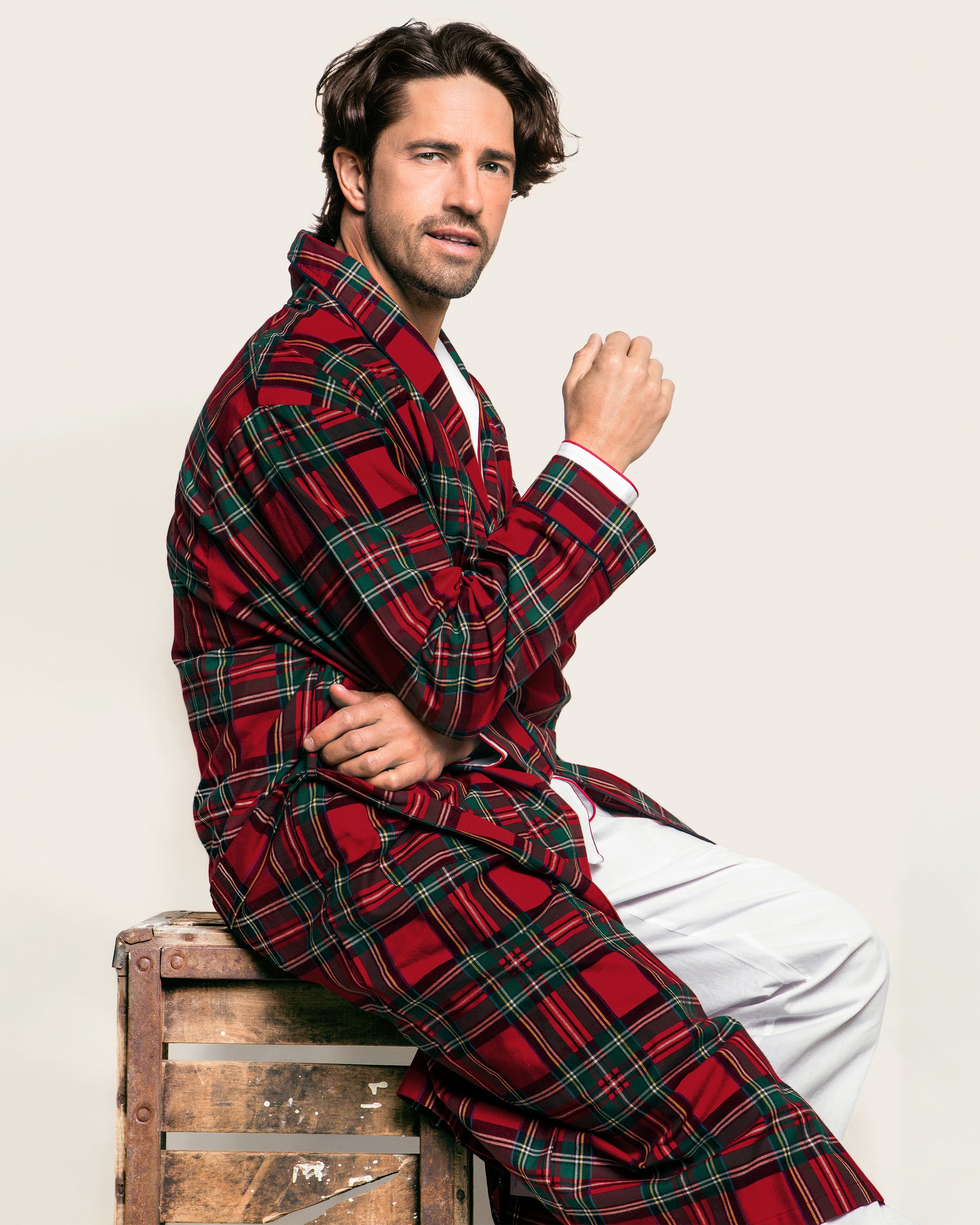 The Men's Brushed Twill Robe in Imperial Tartan features a red, green, and black plaid pattern, long sleeves, a shawl collar, knee-length cut, and includes a matching fabric belt for tying at the waist.