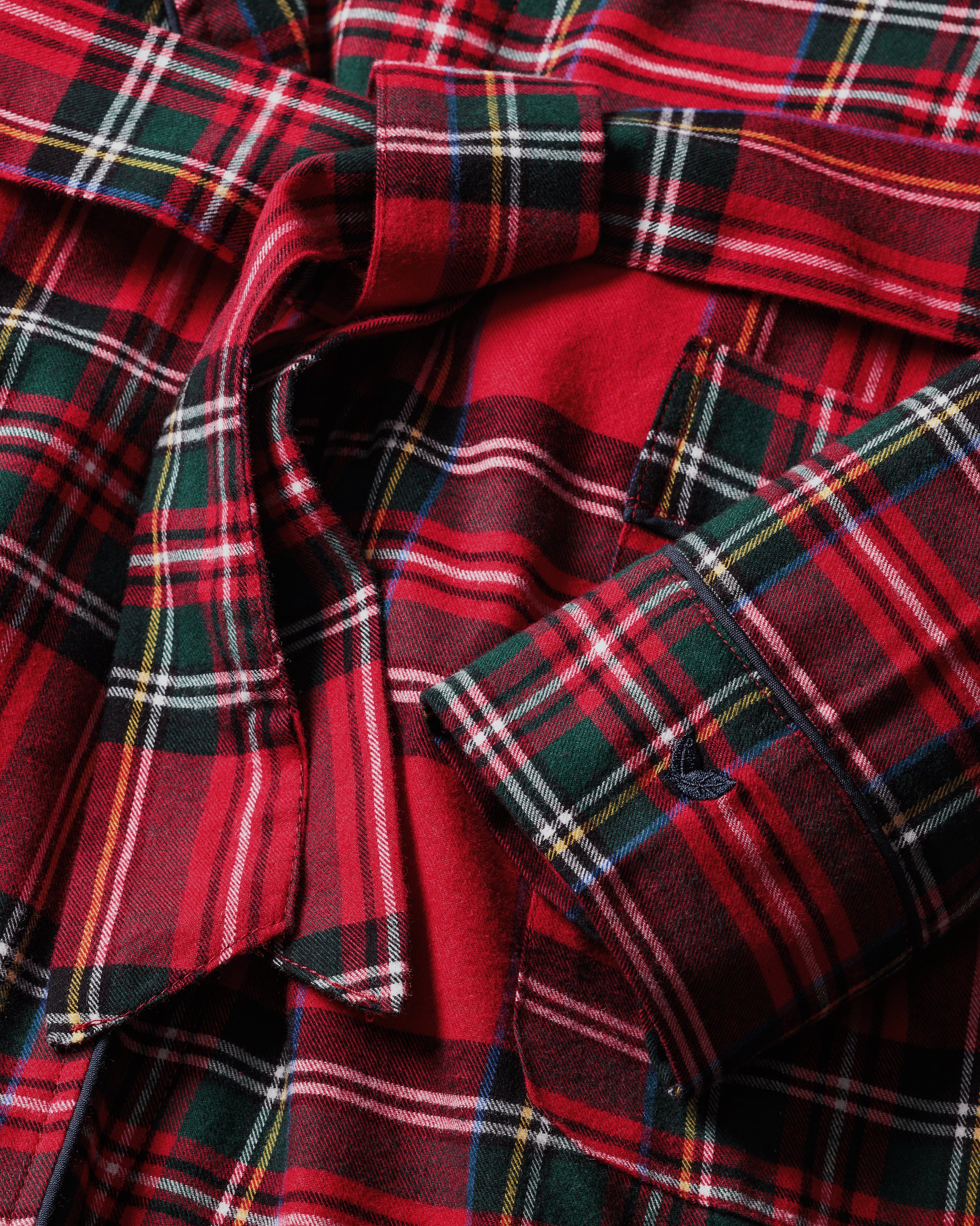 The Men's Brushed Twill Robe in Imperial Tartan features a red, green, and black plaid pattern, long sleeves, a shawl collar, knee-length cut, and includes a matching fabric belt for tying at the waist.