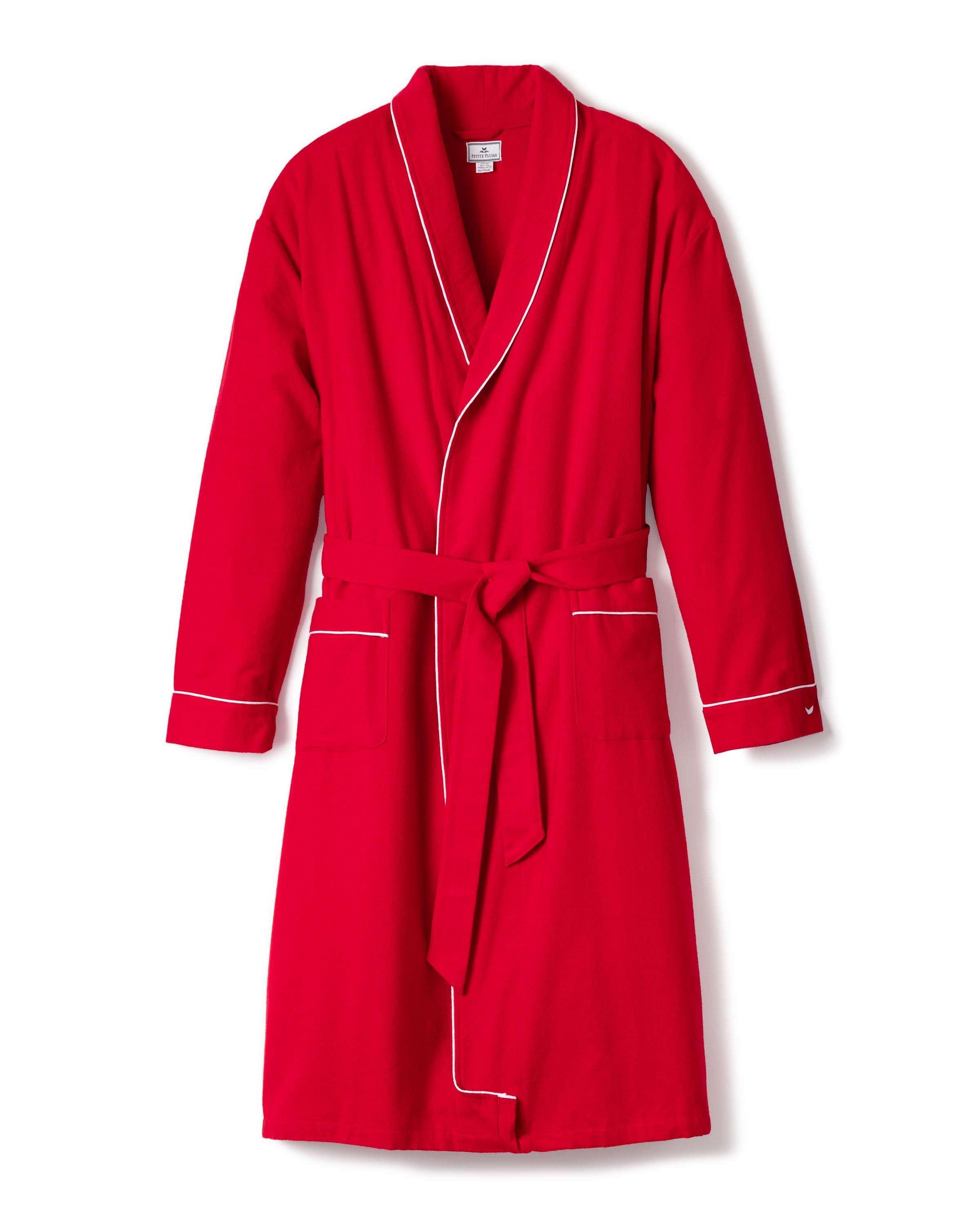 The Mens Flannel Robe by Petite Plume is a luxurious red bathrobe with white piping, featuring a shawl collar, waist tie, and two front pockets. The robe is showcased on a plain white background.