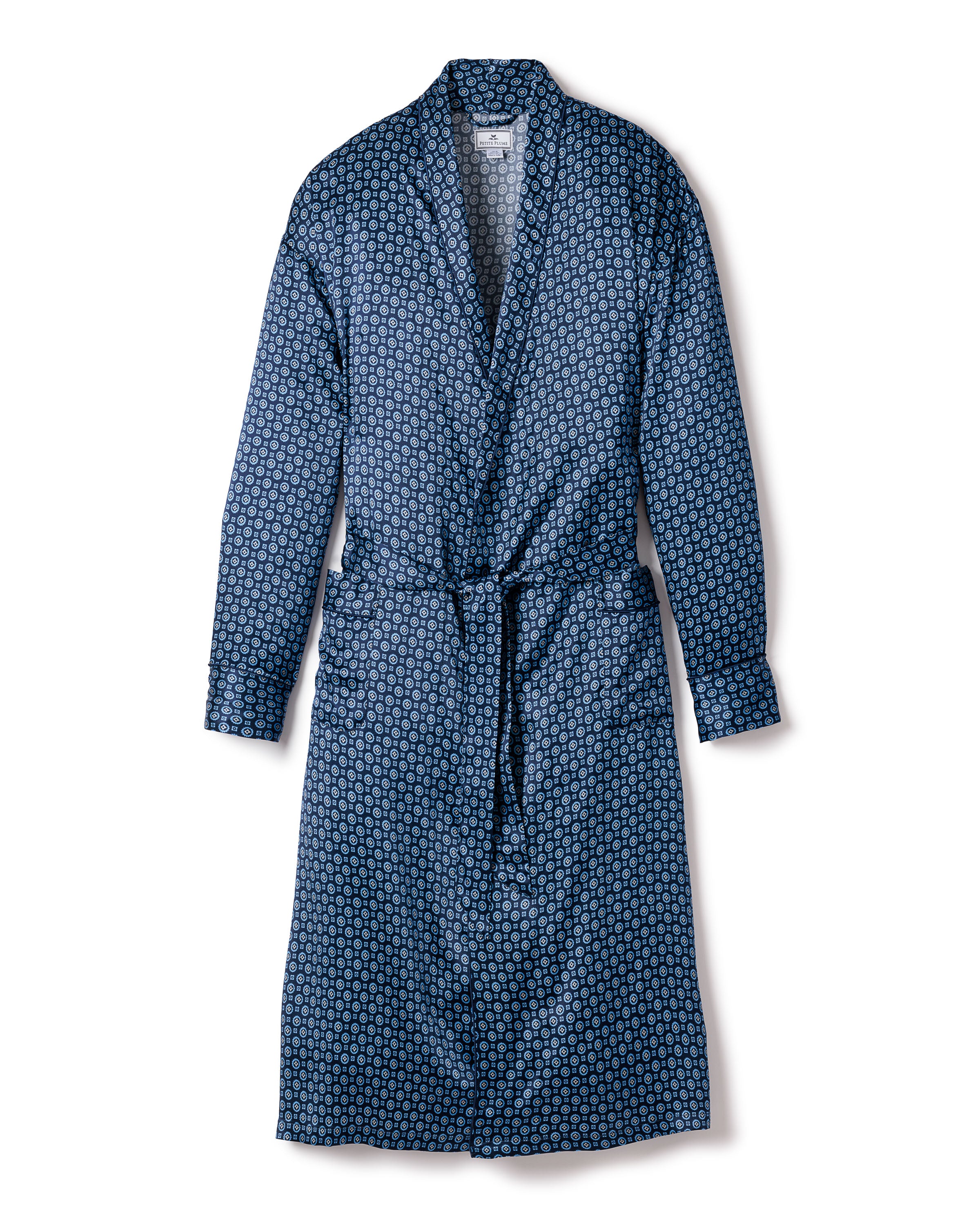 The Mens Silk Robe in Midnight Foulard by Petite Plume is a breathable, long, blue-patterned mulberry silk robe with a belt and subtle repeating shapes against a plain white background.
